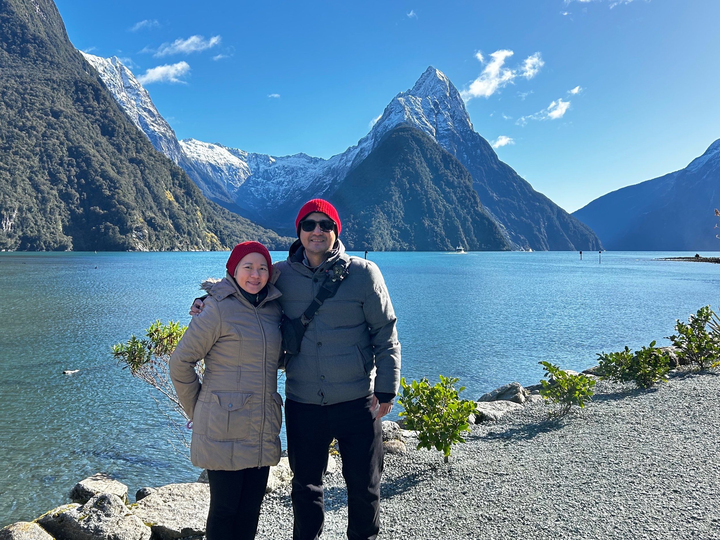 Guests taking a photo in-front of the famous Mitre Peak Milford Sound