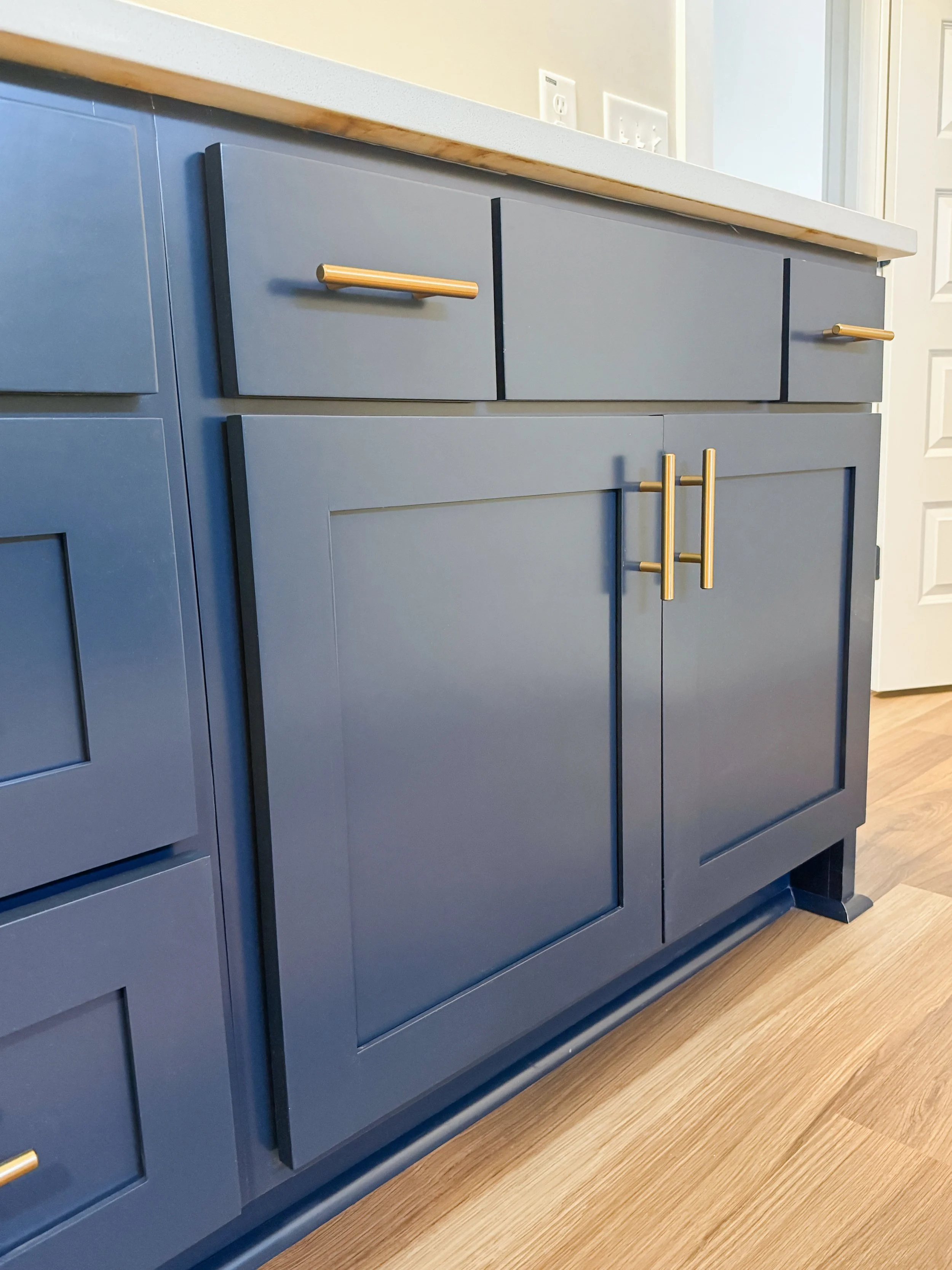 Our "Hall" style doors in Storm blue with gold hardware