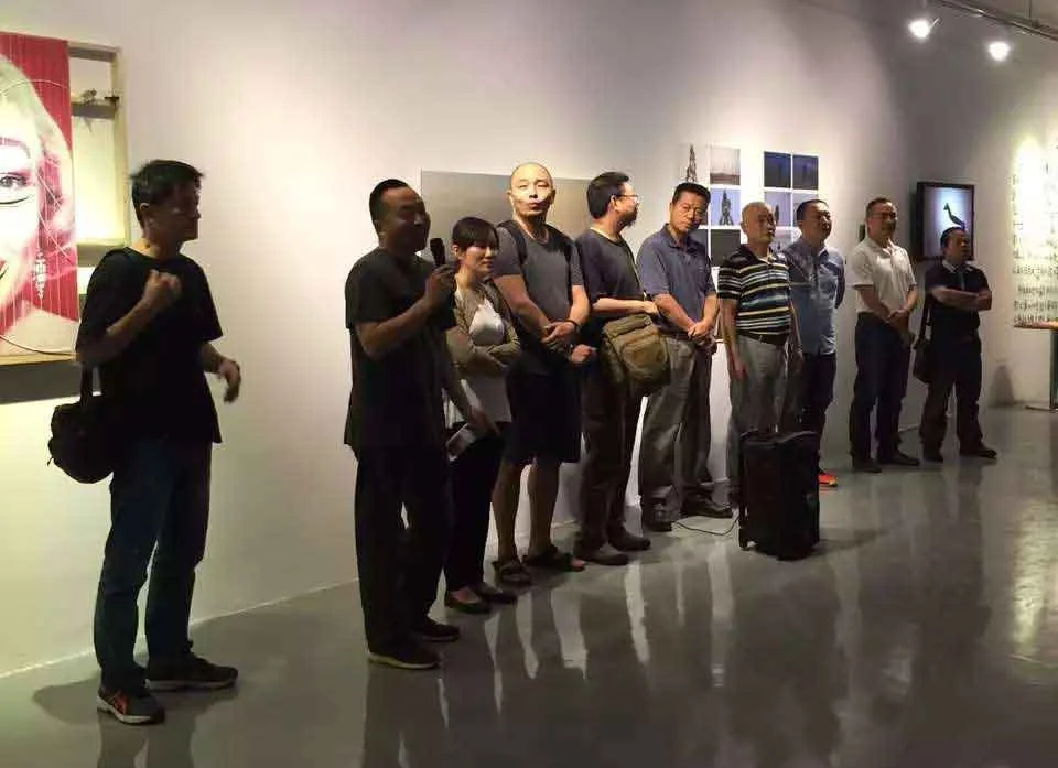 Artist and mentor Le Xi (奚乐) speaking at the SCFAI New Media Art graduation opening alongside university leadership Zhang Jie, Zhang Xiaotao, and Wu Shimin.