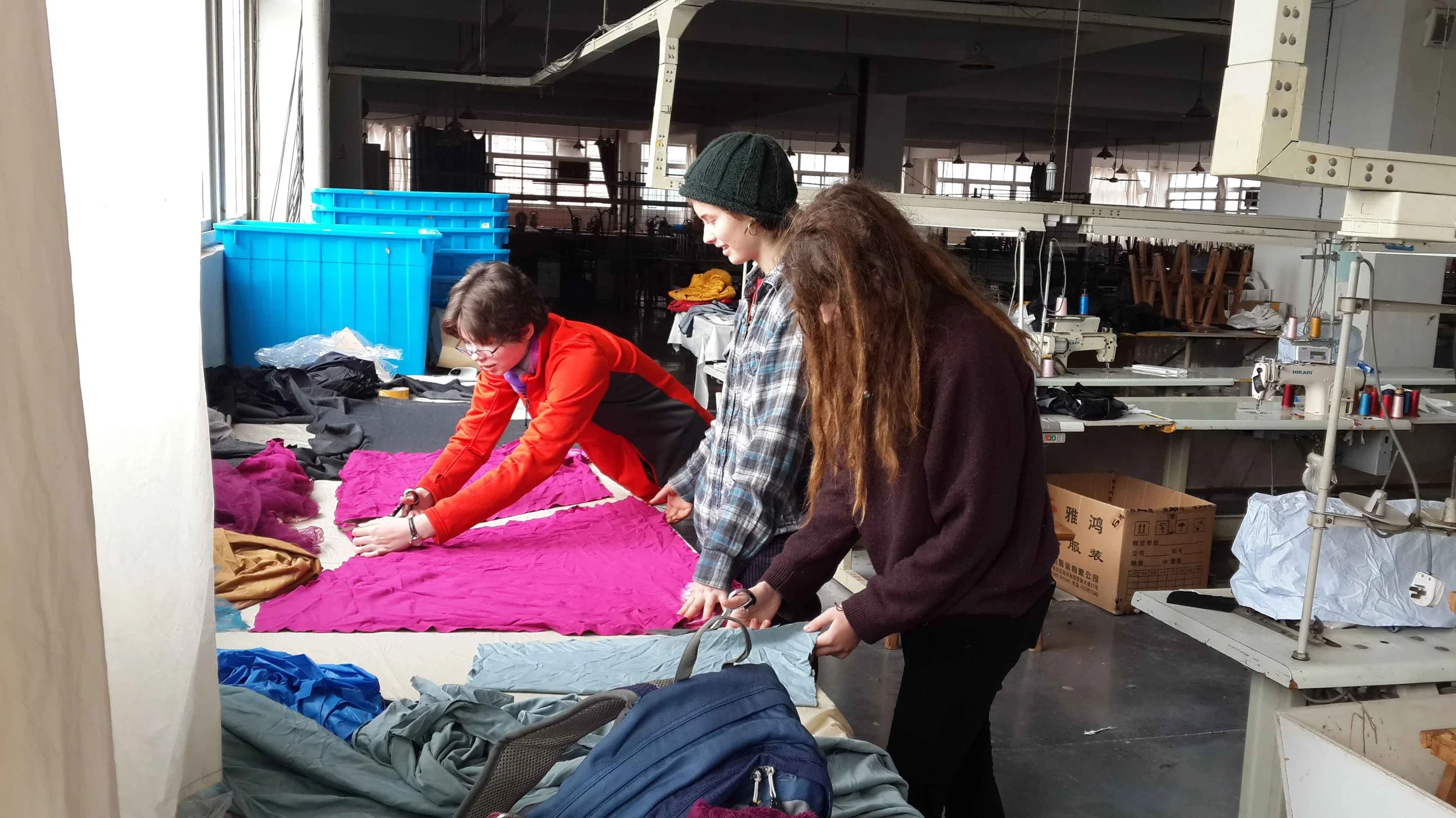 Putney School students making their own garments at a clothing factory in Chongqing, an artistic immersion project guided by Mentor Le Xi (奚乐).