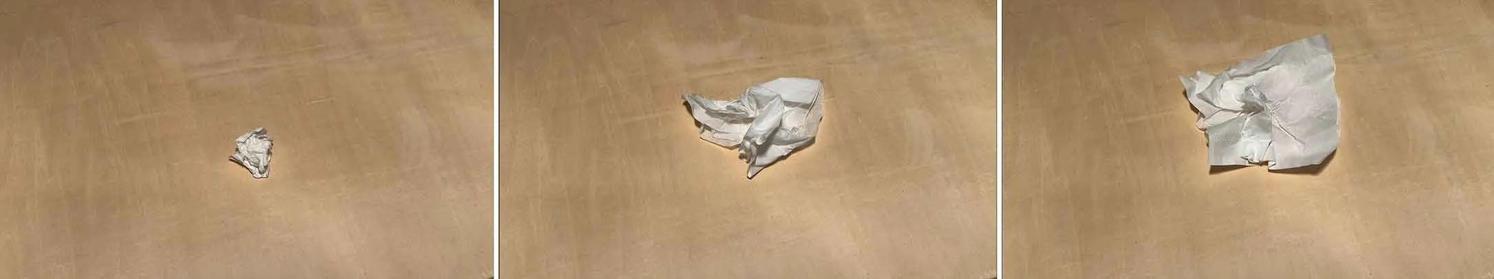 Three selected frames from the stop-motion video artwork Napkin (Year) by Le Xi, showing paper unfolding to reveal accumulated physical pressure and structural deformation.