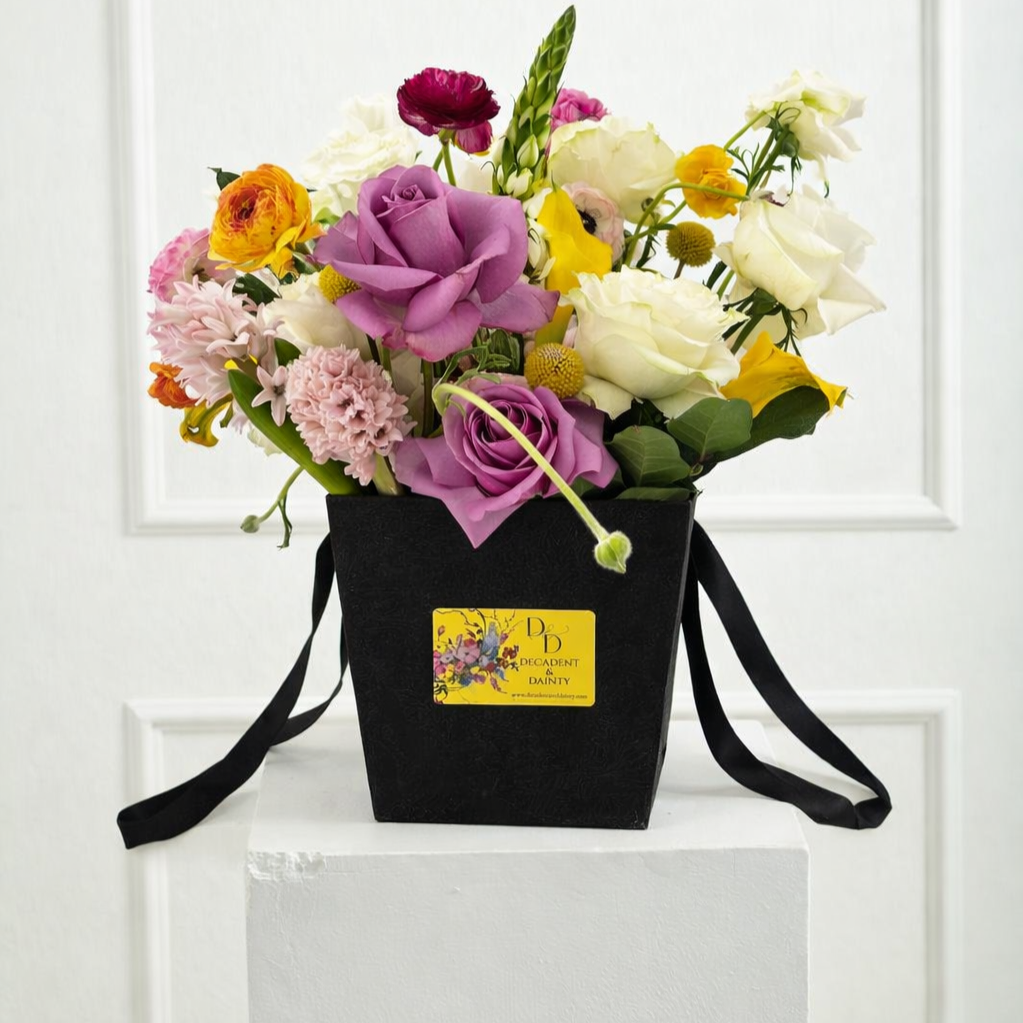Vibrant+floral+arrangement+in+black+bag.png