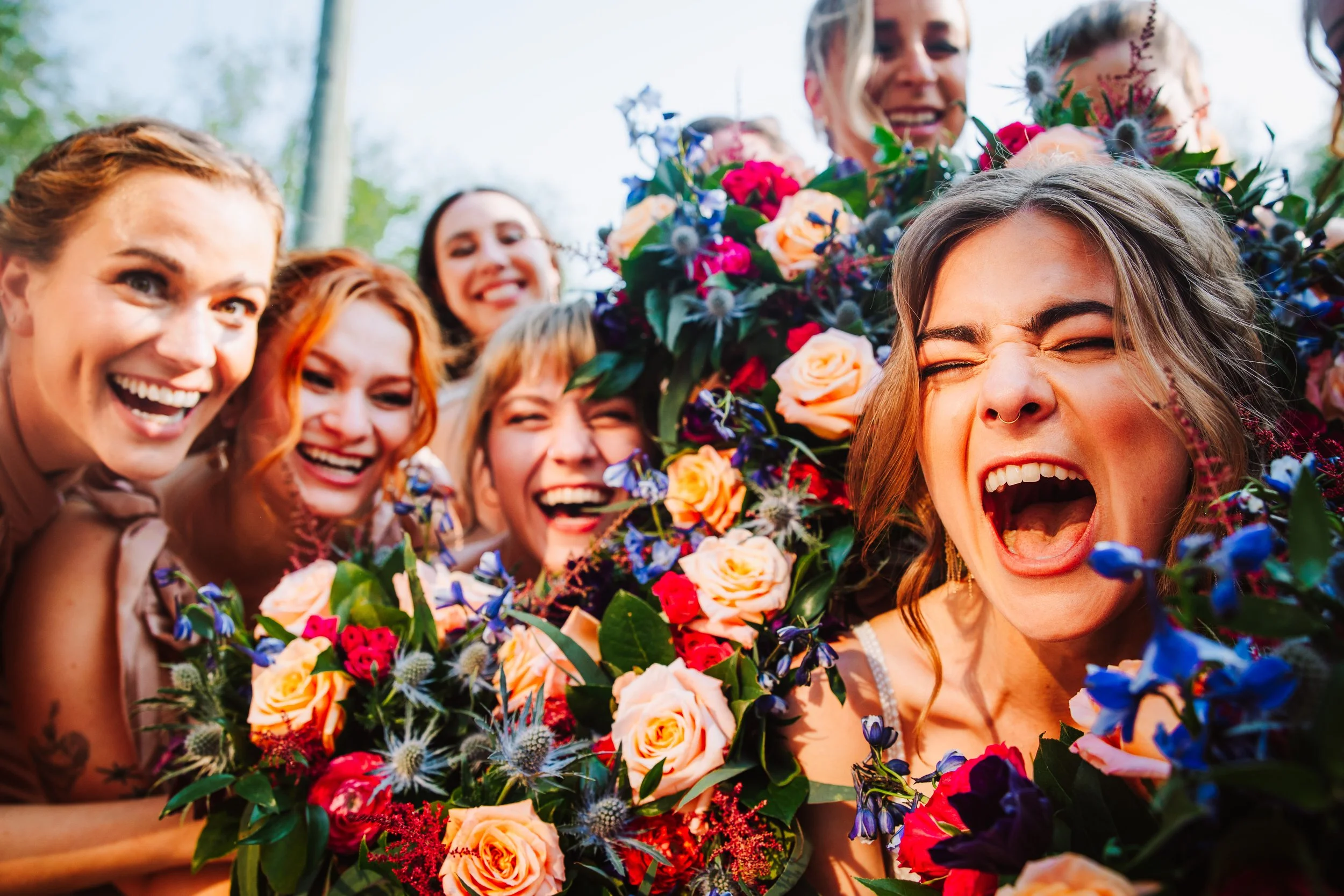 bride and bridesmaids happy with flowers
