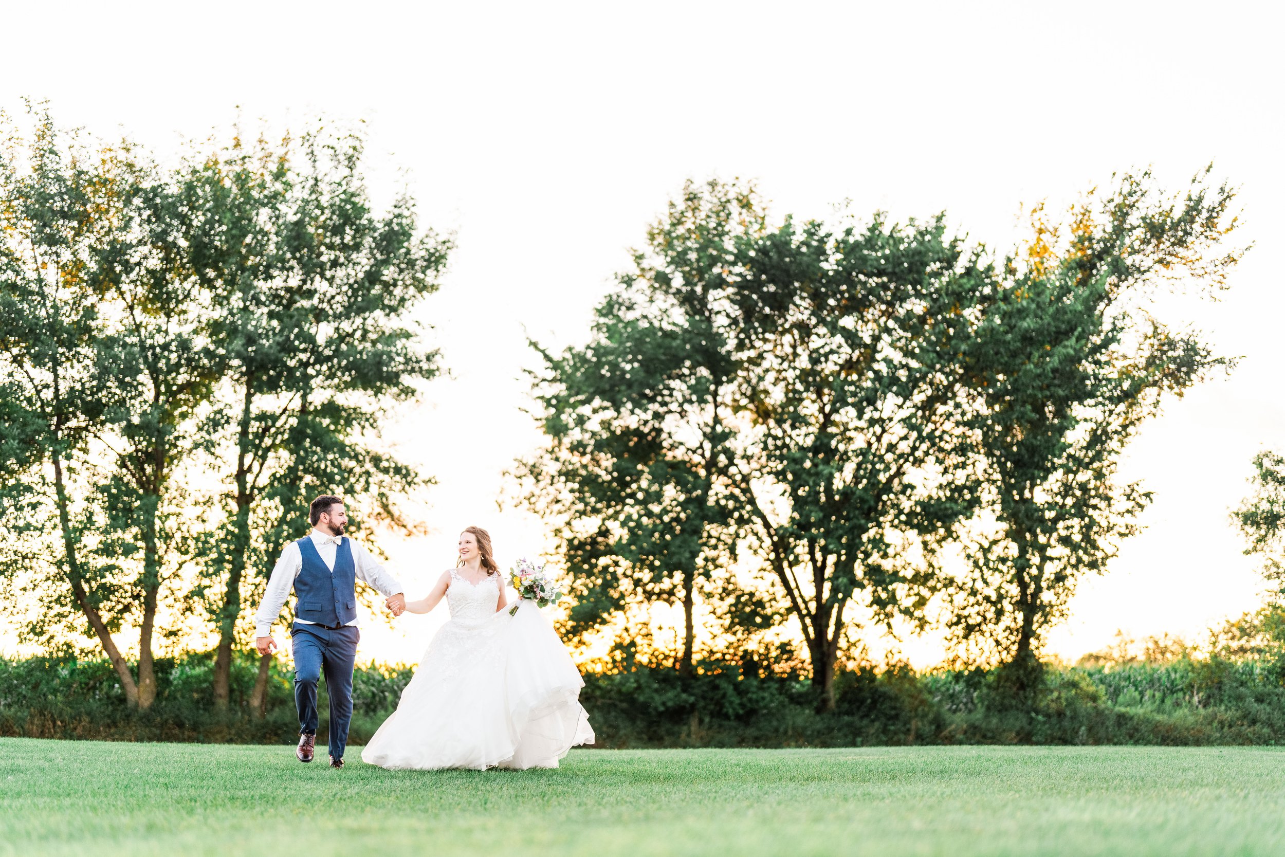 Minnesota Bride and groom running on a golf course.