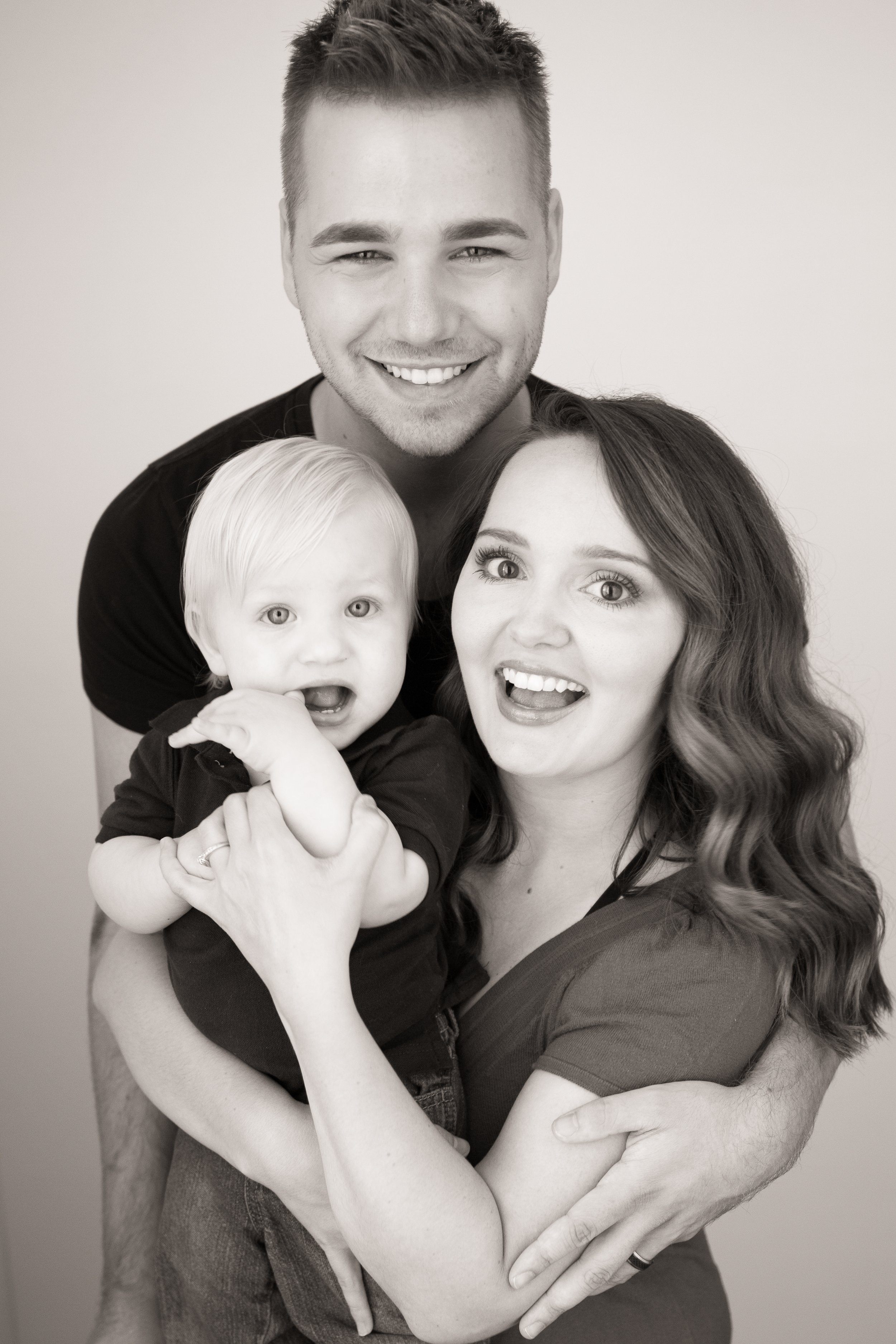 A beautiful studio portrait of a mom, dad, and their little boy, taken by Minnesota Photographer, LKW Photography.
