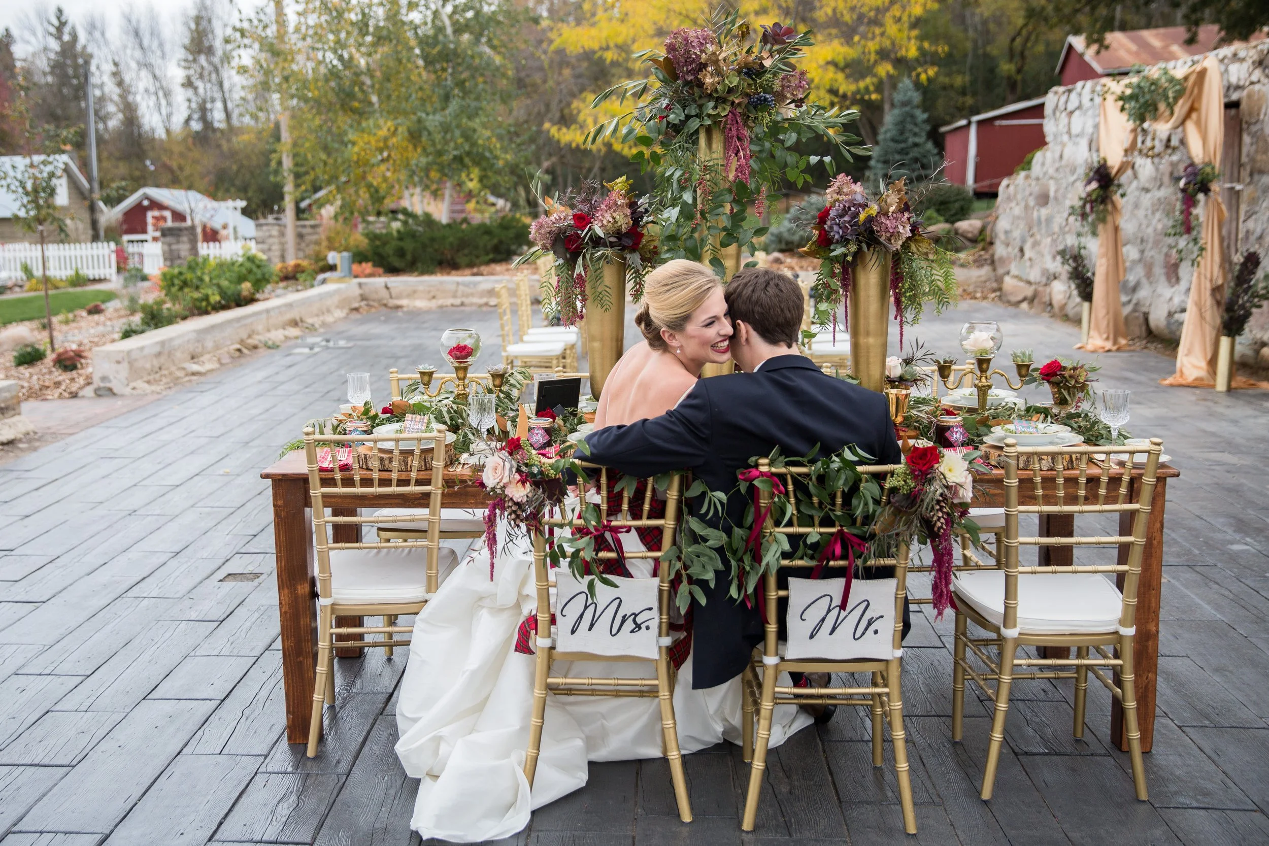 Bride and groom at Rolling Ridge Event Center, enjoying a moment together at their head table, taken by MN photographer LKW Photography.