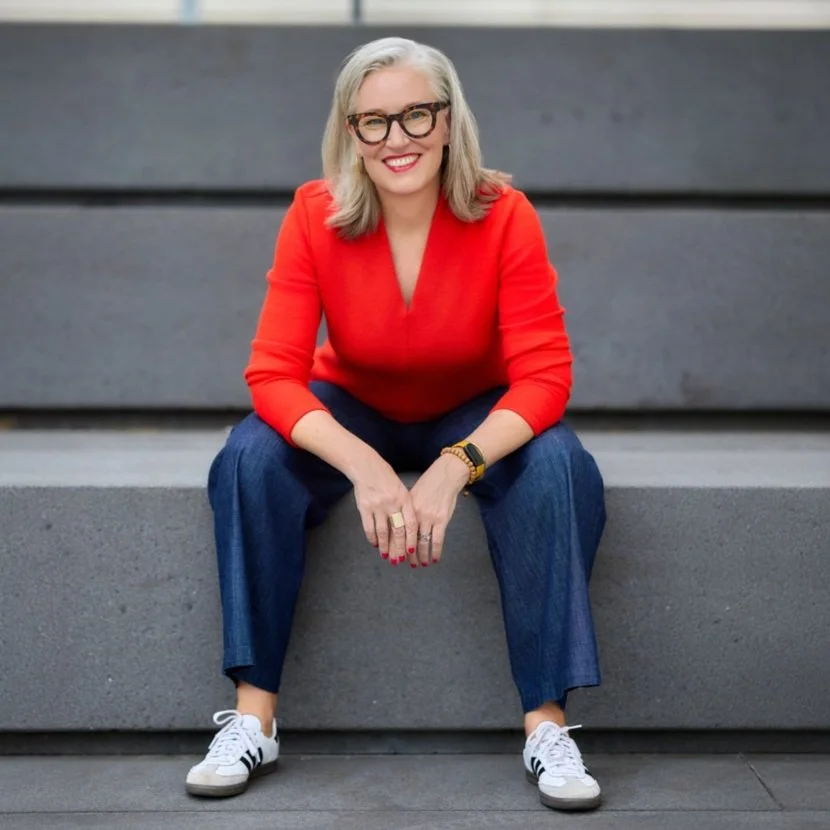 psychotherapist and couples therapist traci ruble sitting on the steps outside her office
