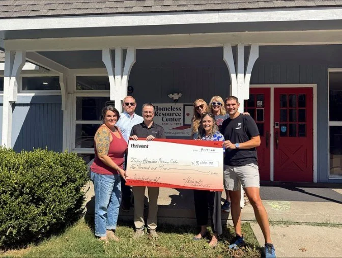The Thrivent team presenting a $5,000 check on the HRC front porch