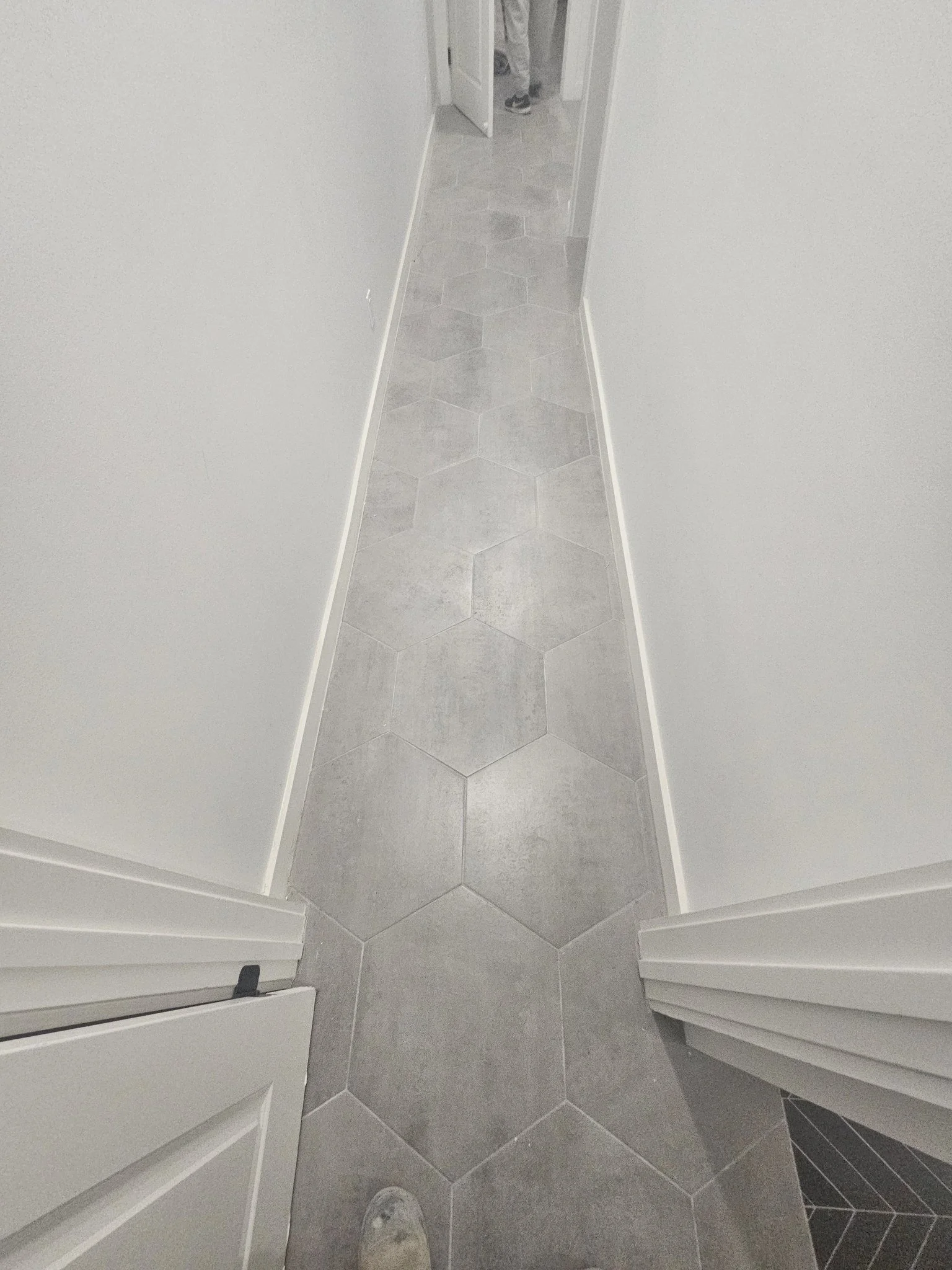 Hexagonal hallway floor tile installation by Arroyos Tile and Granite Inc.