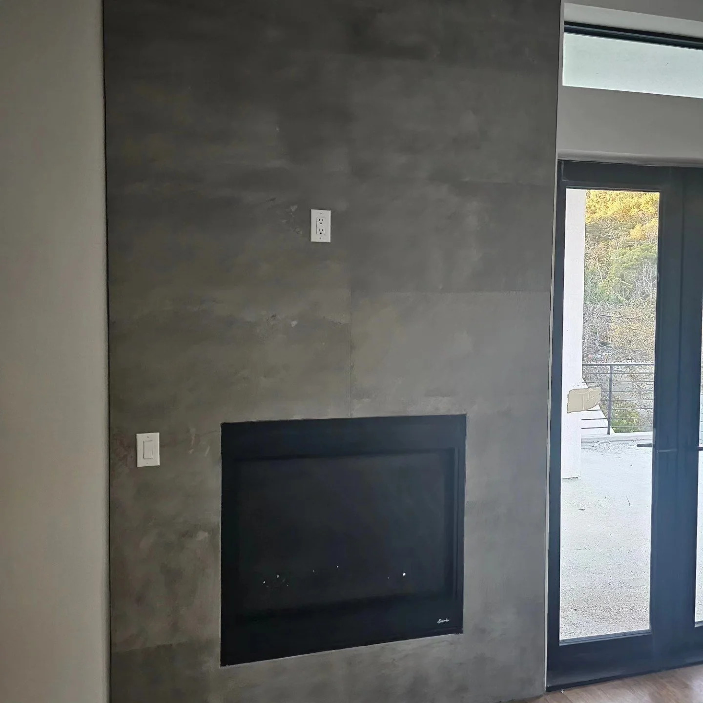 Fireplace surround finished with gray tile by Arroyos Tile and Granite Inc.