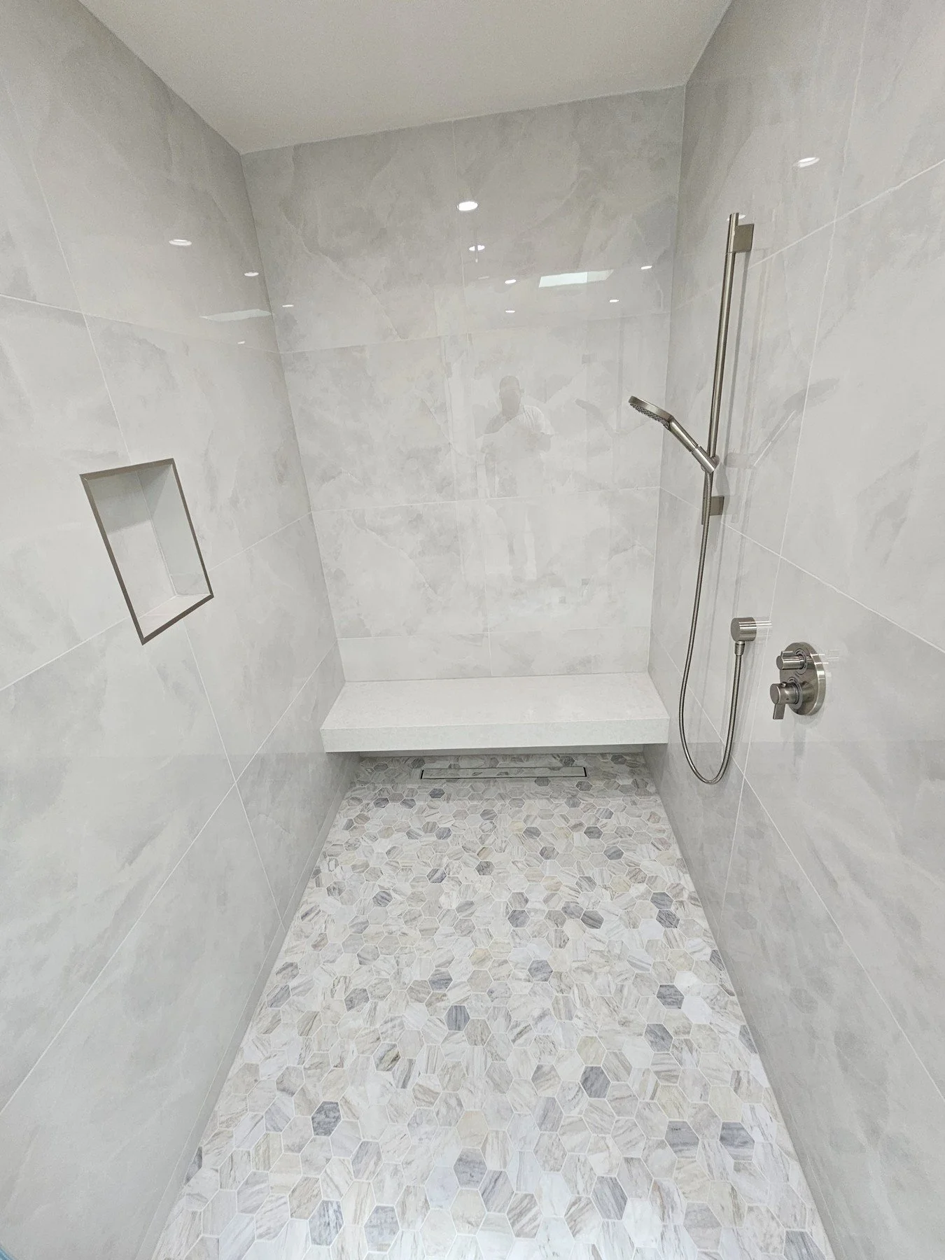  Shower Tile Installation   Tile for shower walls, pans, curbs, niches, and benches. Surface preparation and waterproofing requirements are reviewed as part of the agreed project scope.   Explore Bathroom Remodels → 