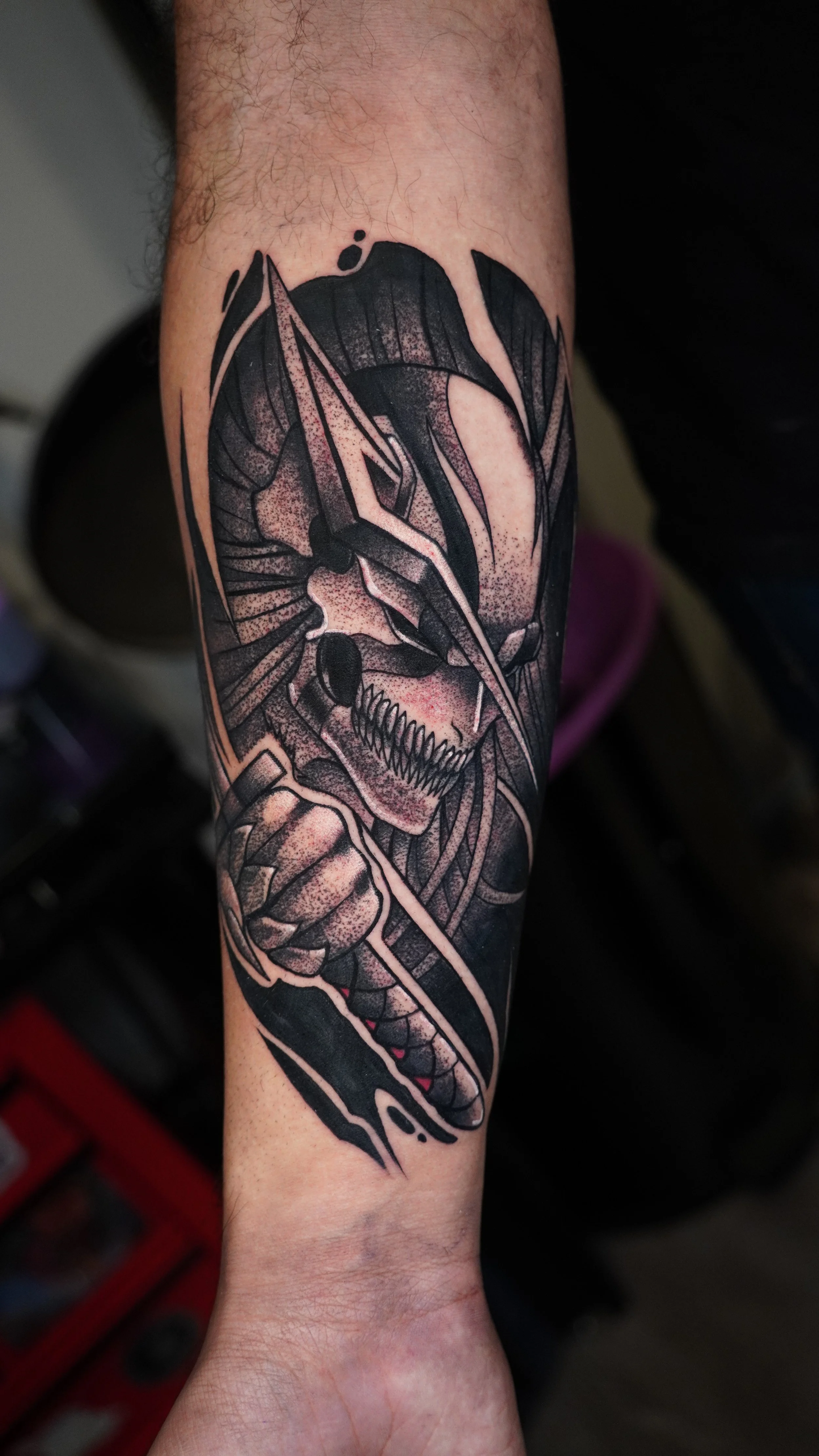 Black and gray tattoo of  Vasto Lorde Ichigo featuring intense shading and bold lines on a forearm.
