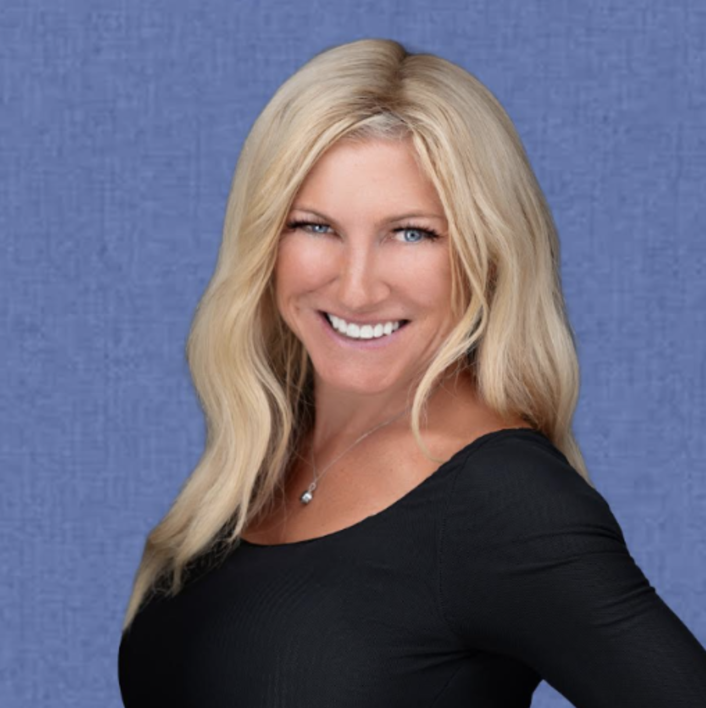A blonde woman on a blue background, wearing a black shirt. Joanna Cockerline, the author of Still