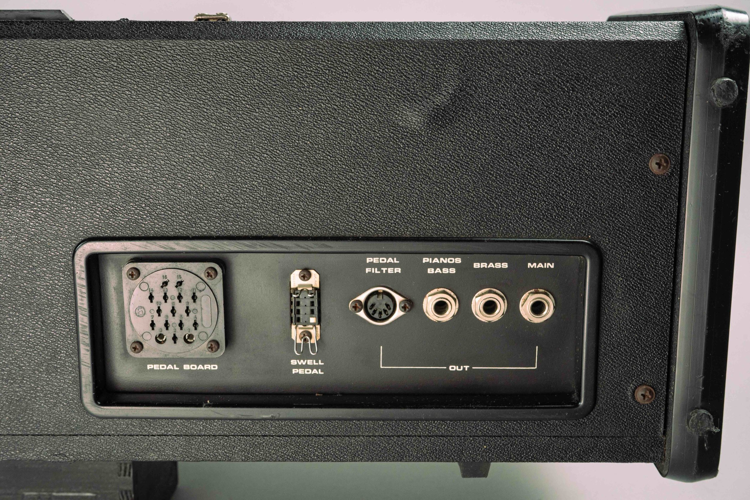 On the back the big round connector is for a 12 note foot pedal for the bass section and the pedal filter input is for controlling the brass sections' cut-off filter, we're also blessed with an ambitious swell pedal connector with a 7-pin Plessy layo