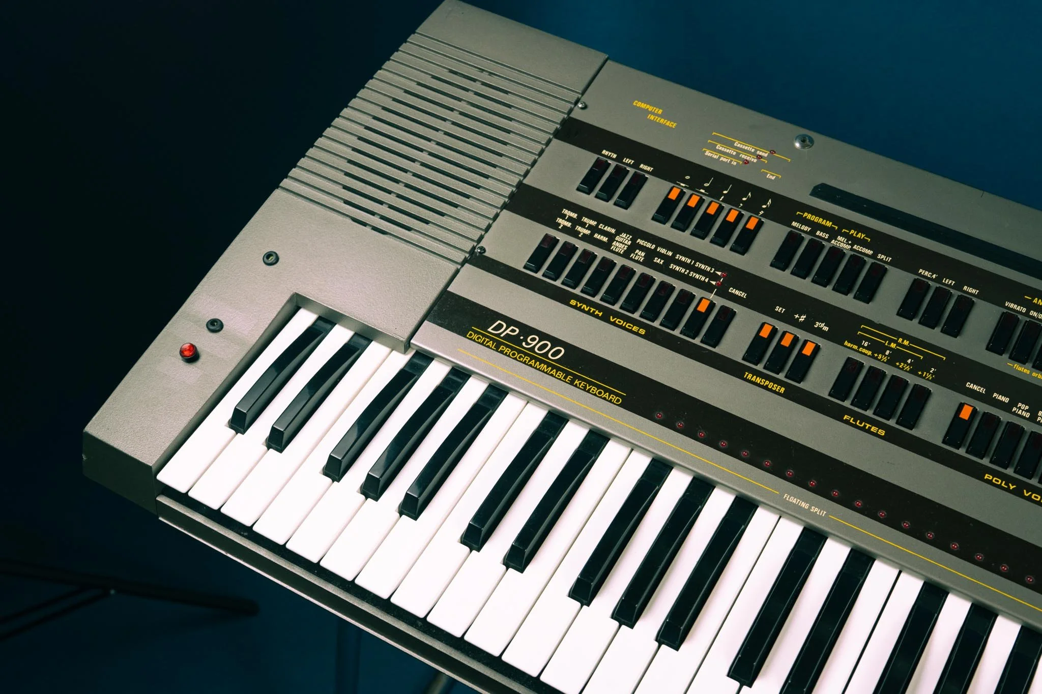 The DELTA DP-900 looks like a large hobby keyboard. Think of an early 1980s Casiotone for instance, but this one is a lot heavier and crammed with circuitry. 
The drum section and monophonic synthesizer are fully analog (the mono and poly section is 