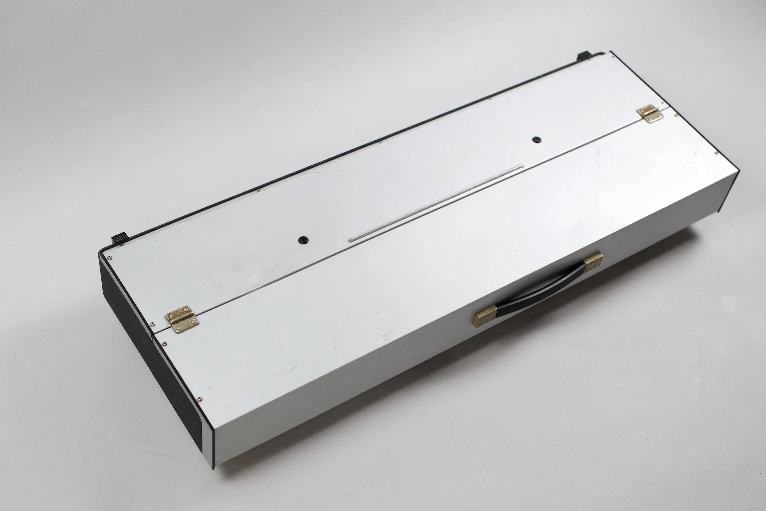 The Farfisa Syntorchestra comes with a lid and closes to become a silver monolith with a handle. There is also a wooden version with the same guts and controls released around the same time.