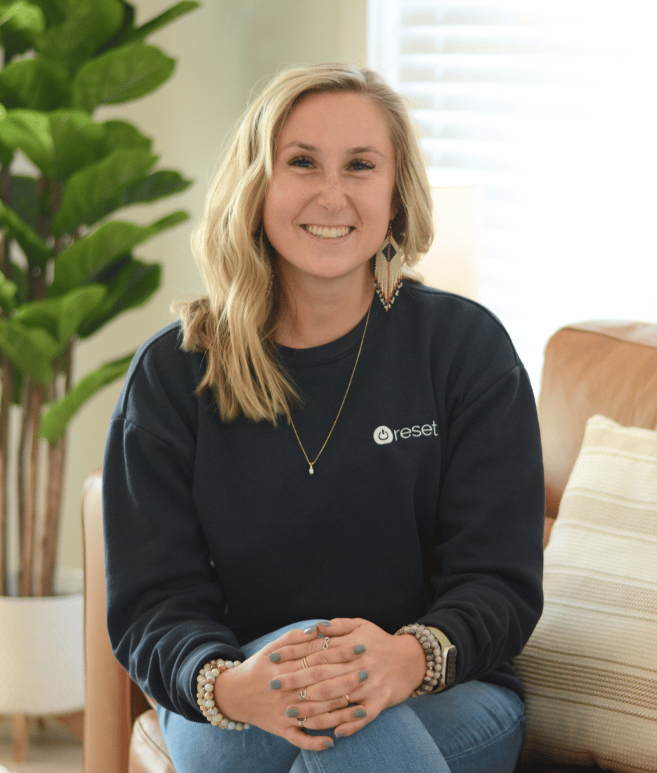 Therapist Jordyn Kahler smiles from her Reset office