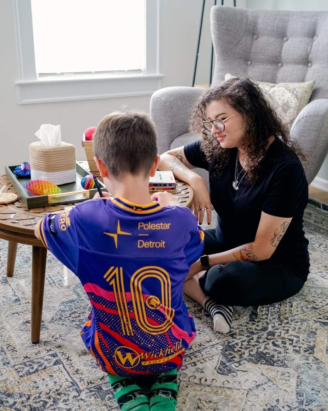 Therapist Maddy Hunwick works on an art therapy project with an adolescent boy