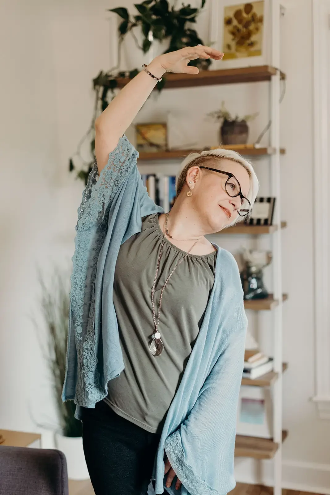 an older woman wearing glasses stretches to the side