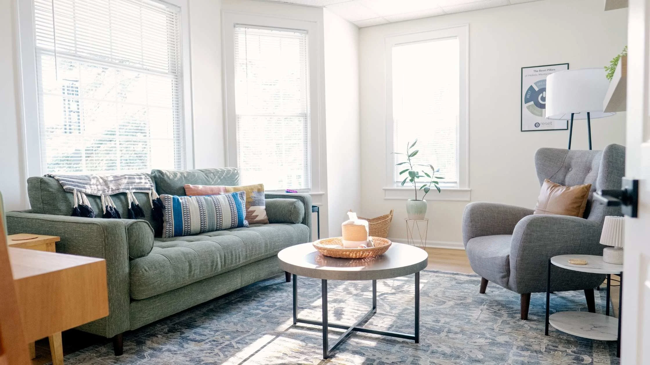Reset Brain and Body office with green couch and windows