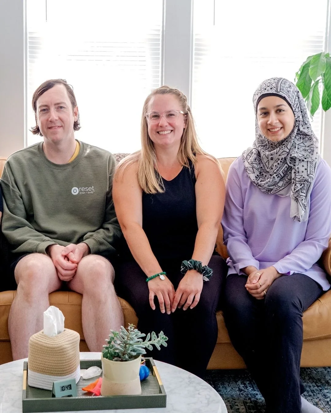 Three Reset therapists sit on a couch.
