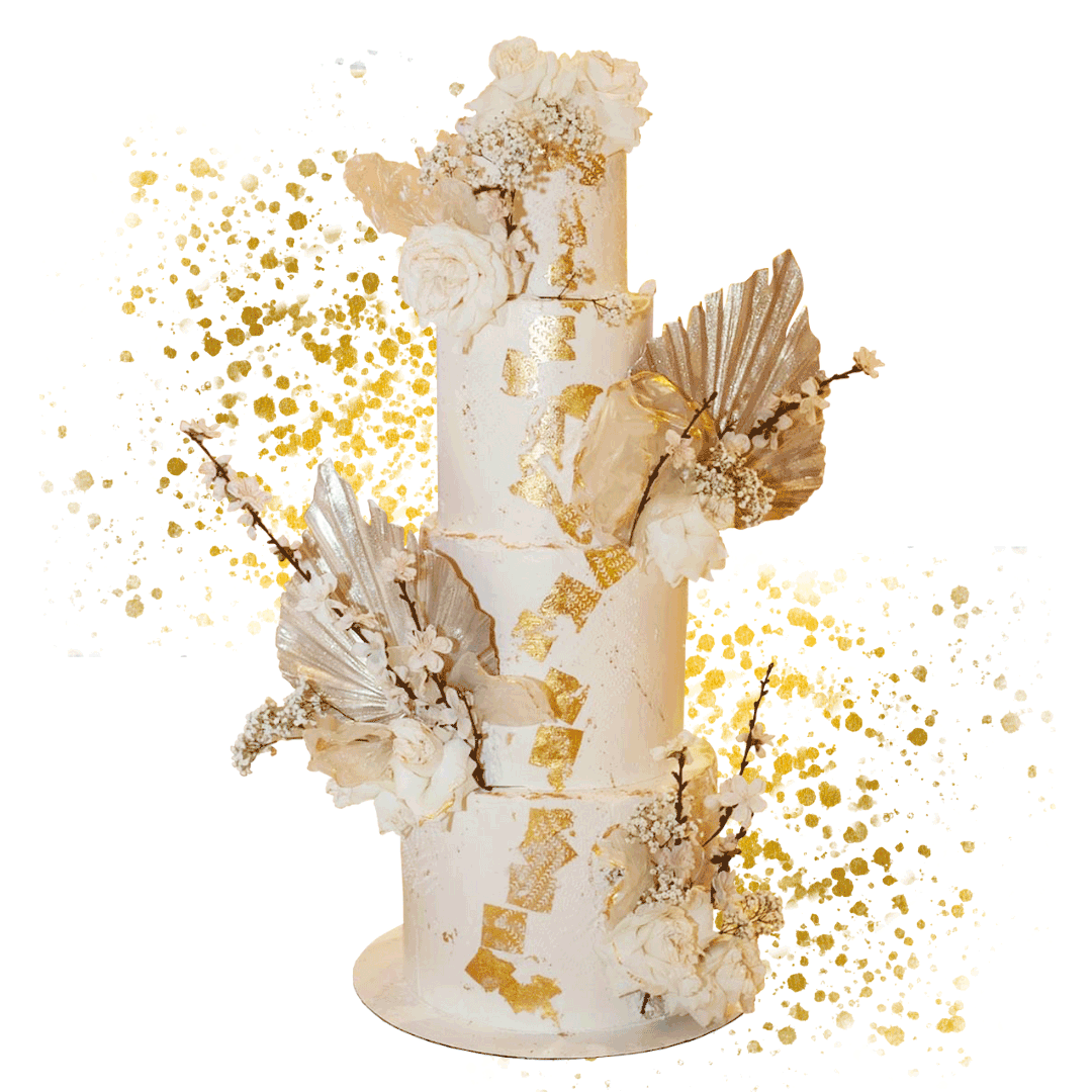 A tall, multi-tiered white wedding cake decorated with white flowers, gold leaf accents, and metallic gold and silver leaf decorations, with a gold and white splattered background.