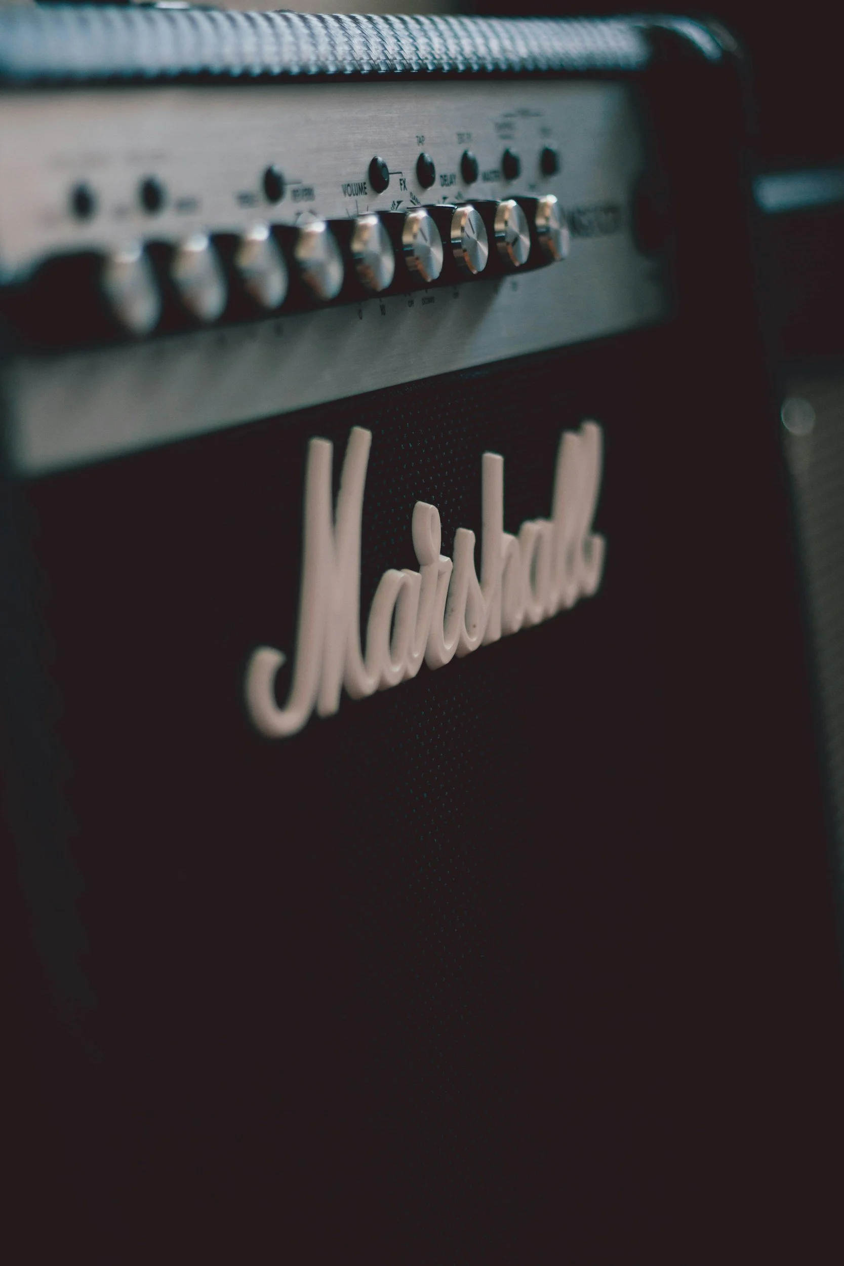 Close-up of a Marshall guitar amplifier with the brand logo and control knobs.
