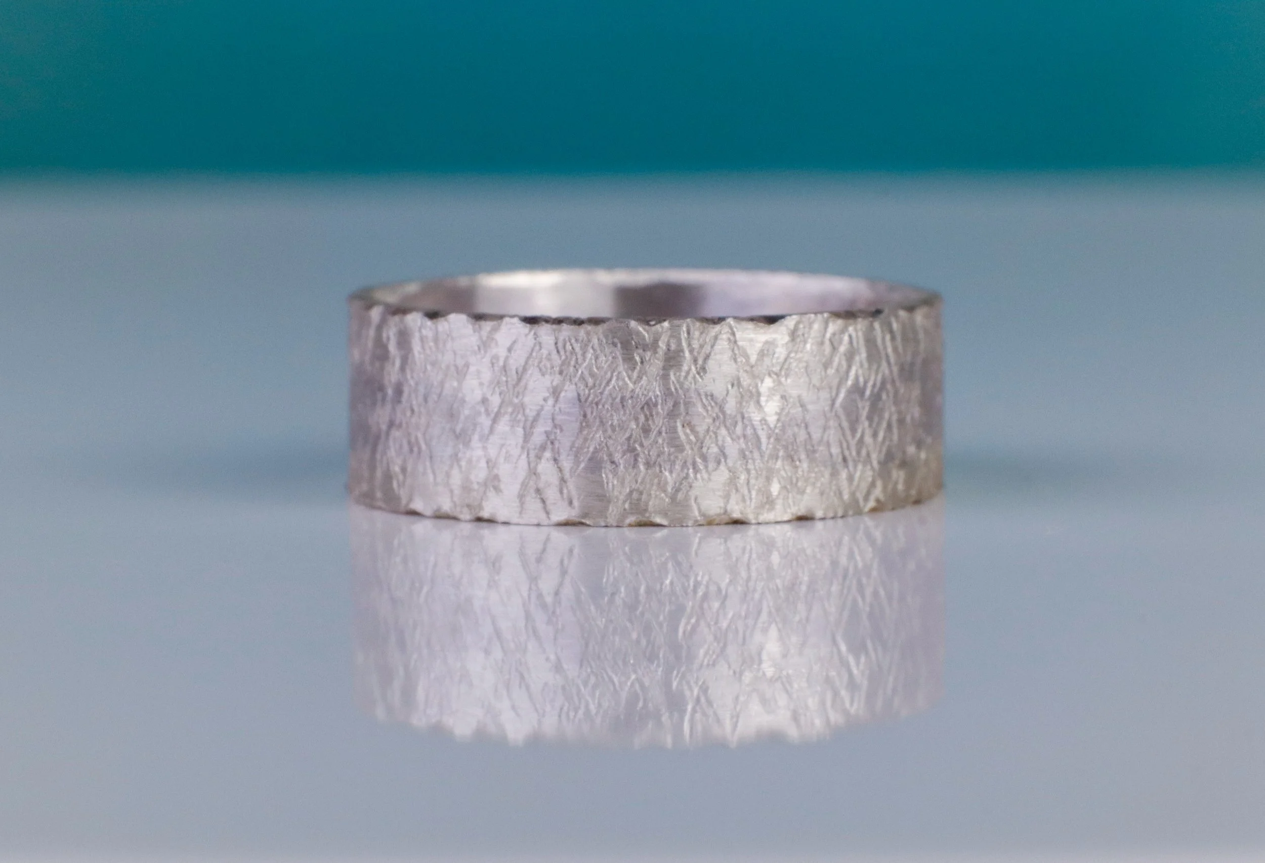 Wide Silver handcrafted ring resembles icecrystals on a frozen surface