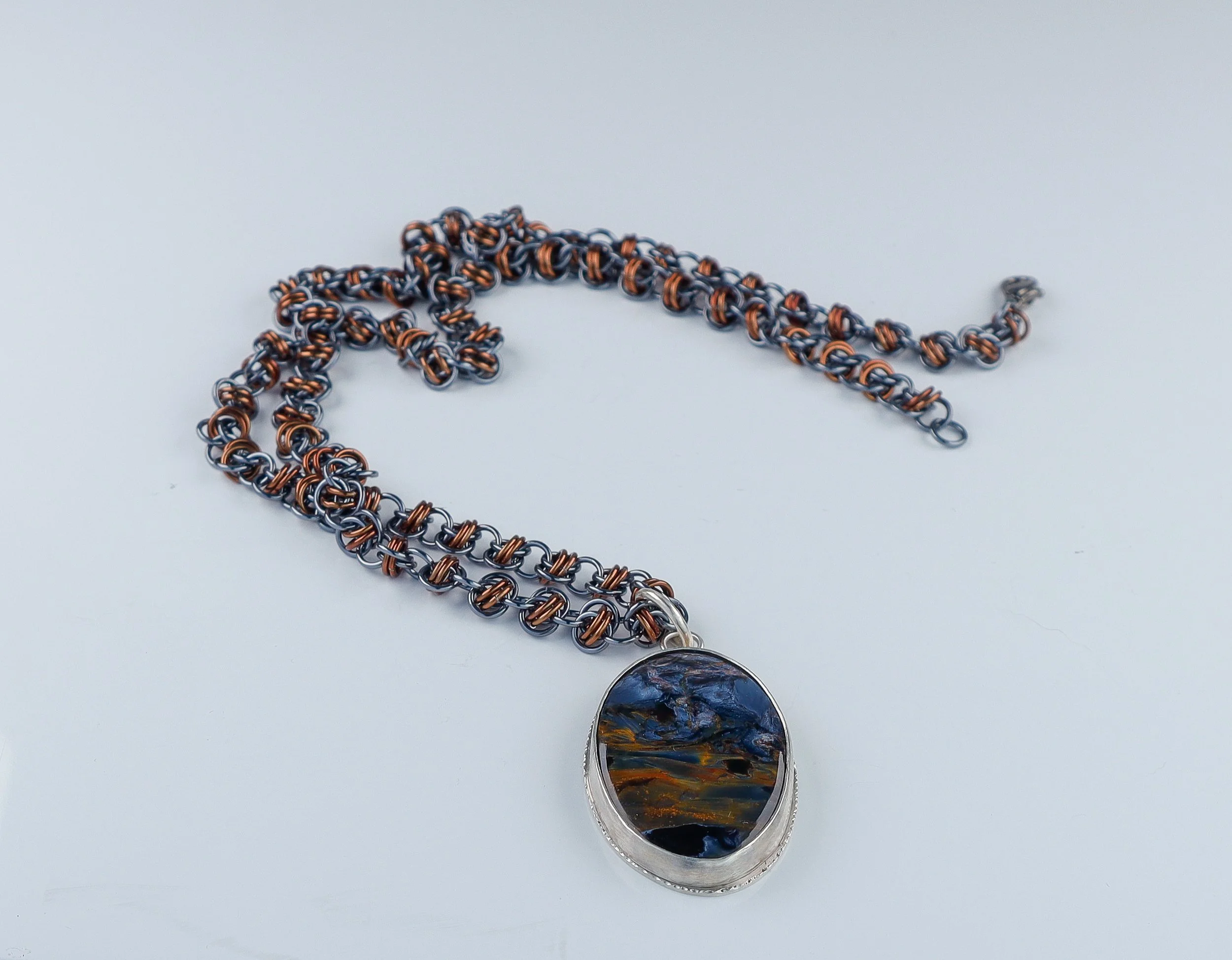 Oval pietersite in silver with bronze and grey handwoven chain