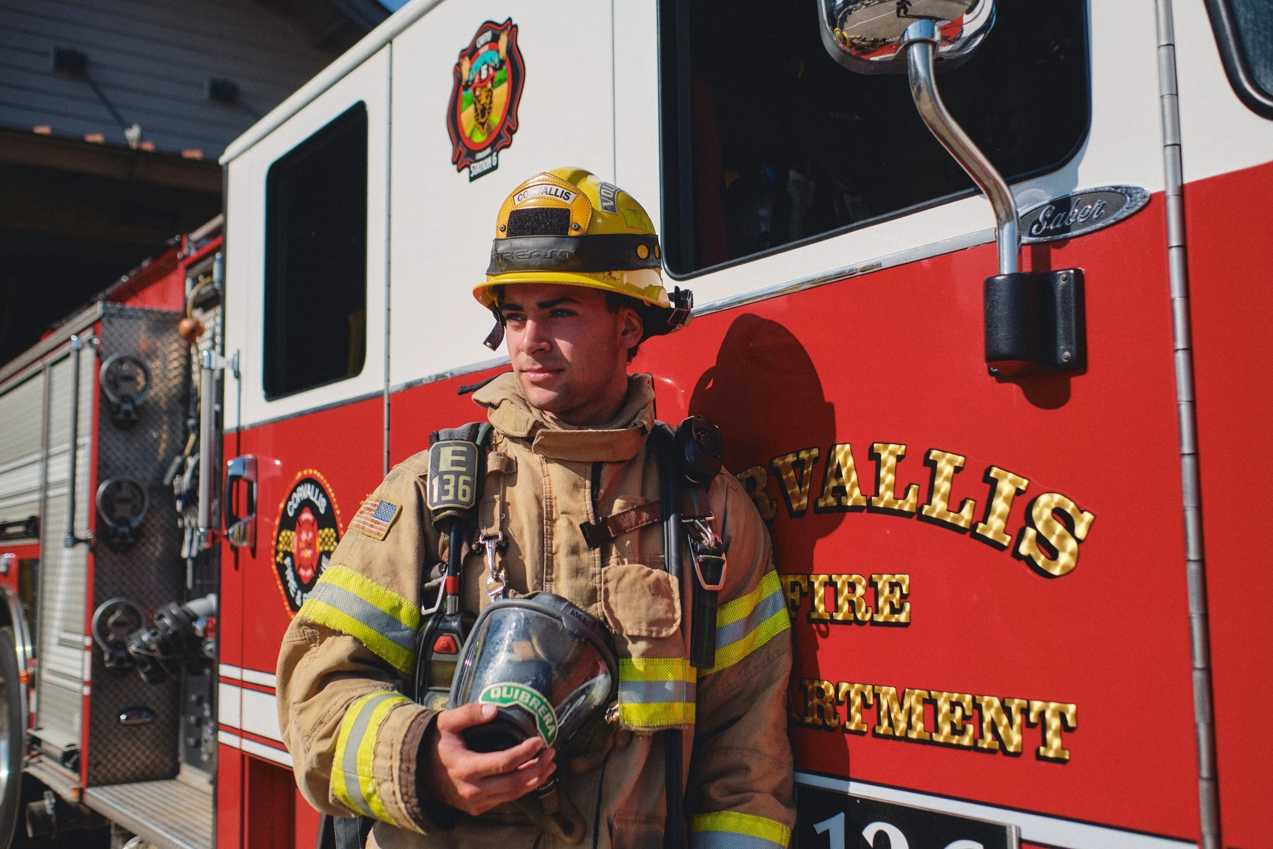 Corvallis Fire Department firefighter portrait beside a fire engine