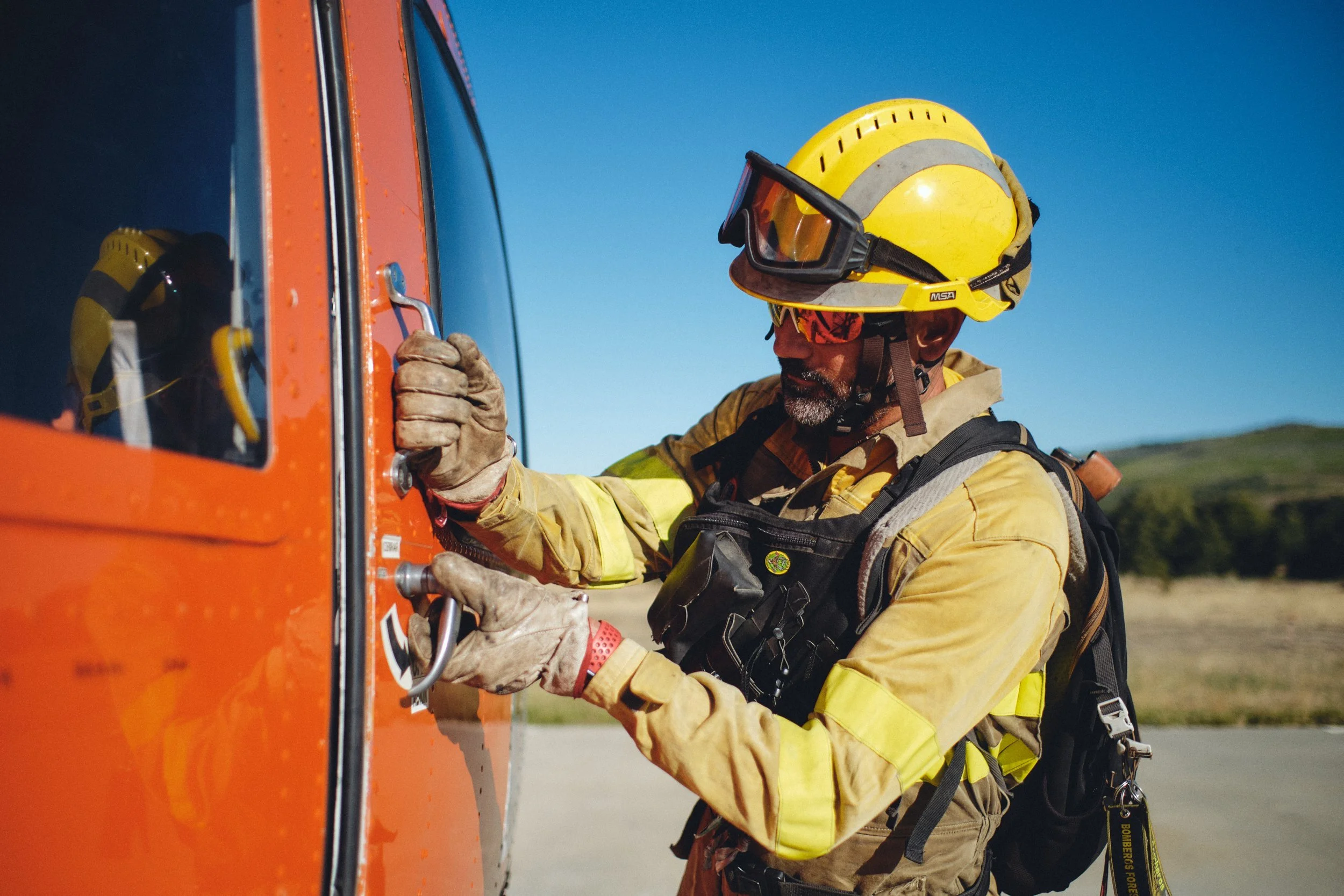 Wildland firefighter at a helicopter door in Spain