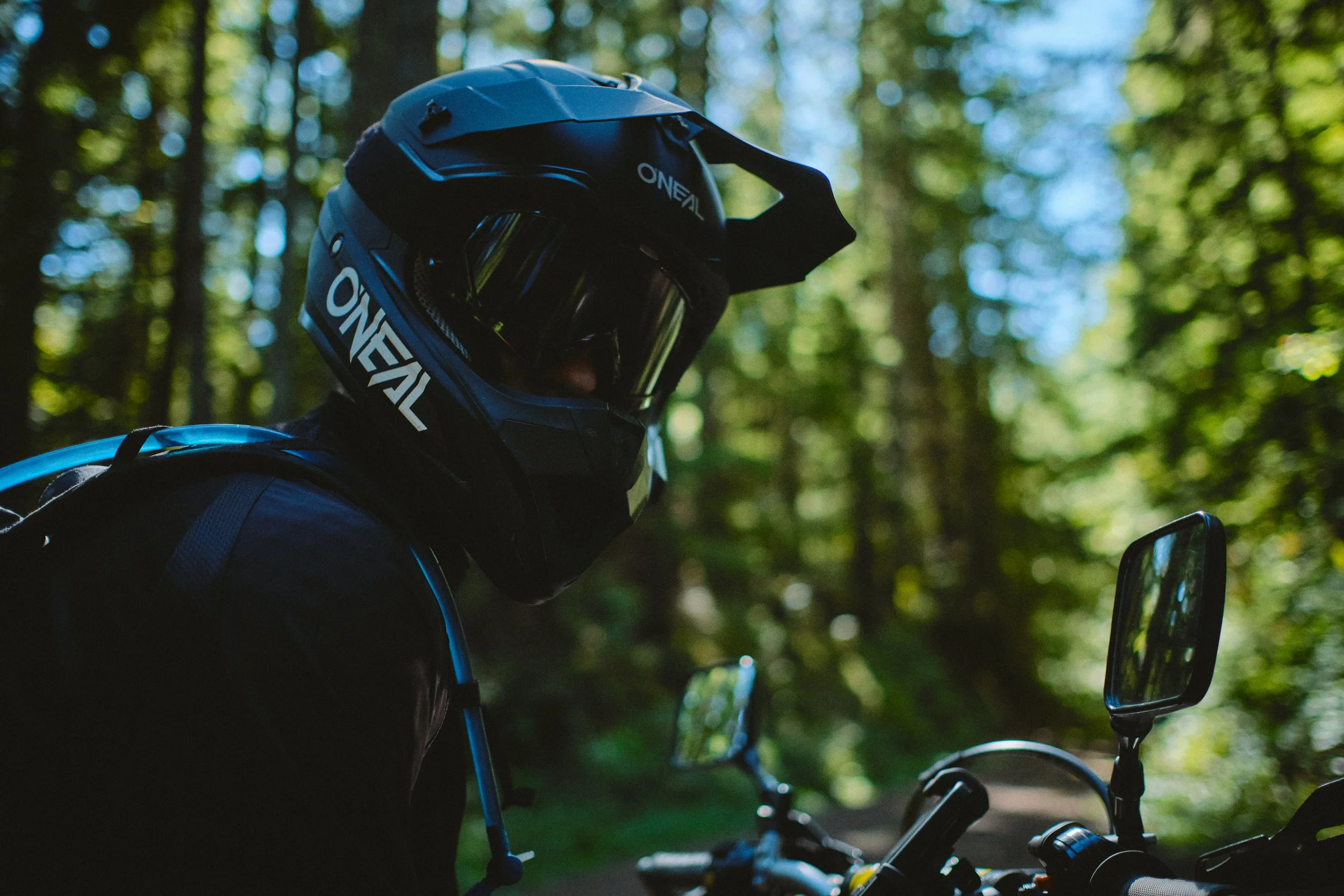 Motocross rider in a helmet in a Pacific Northwest forest
