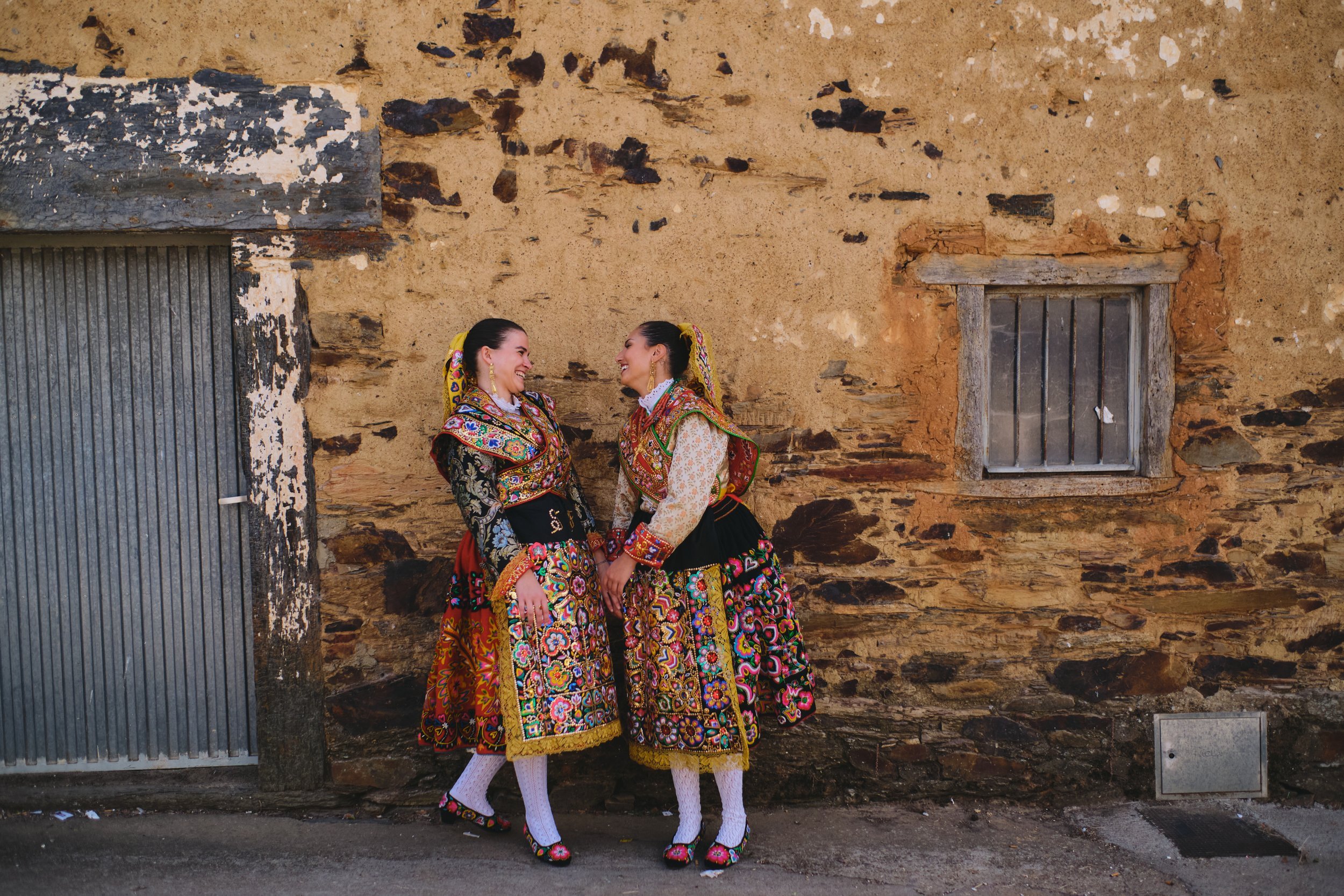 Two women in traditional dress during Los Quintos in Spain