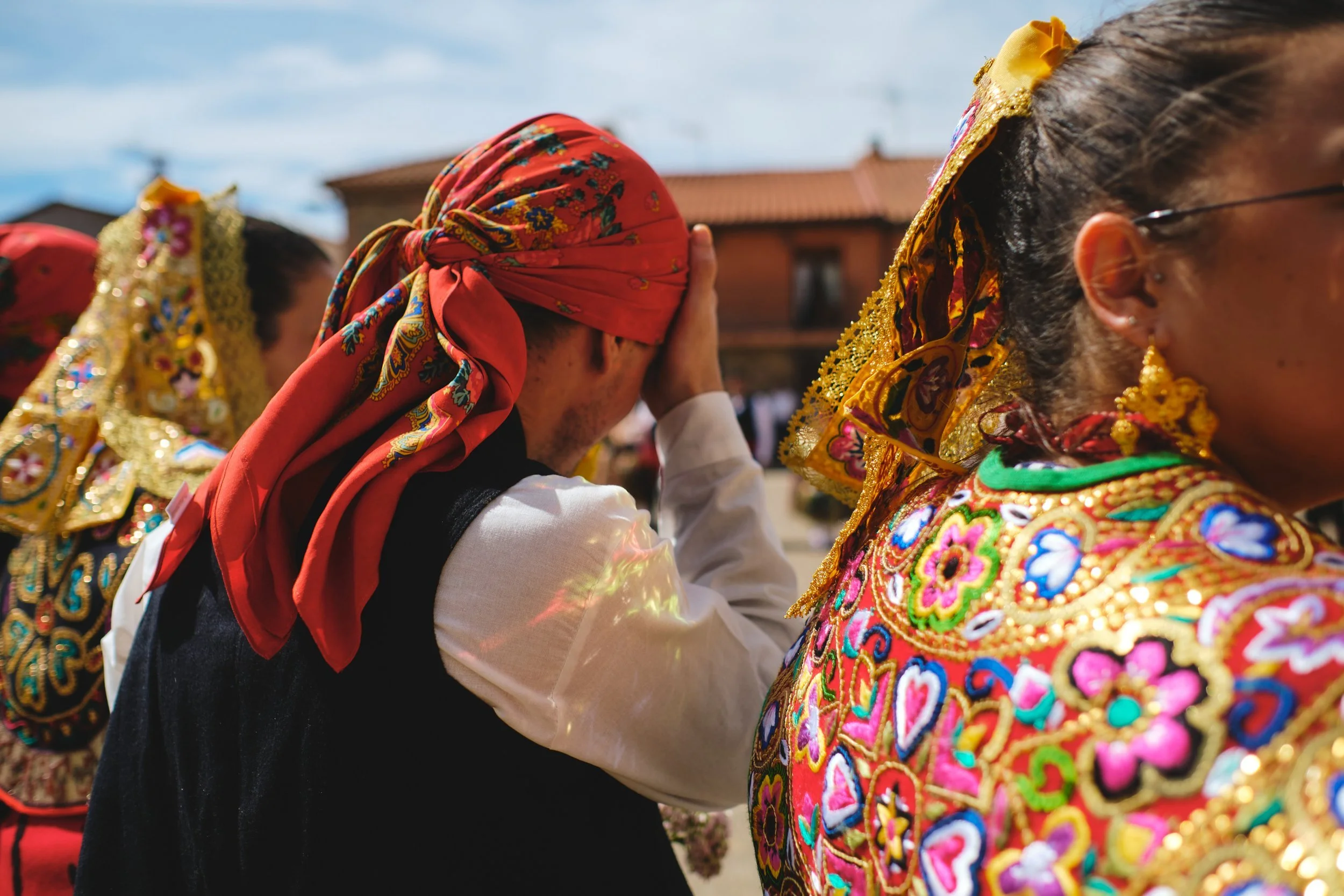 Woman in a red headscarf at a village festival in Spain