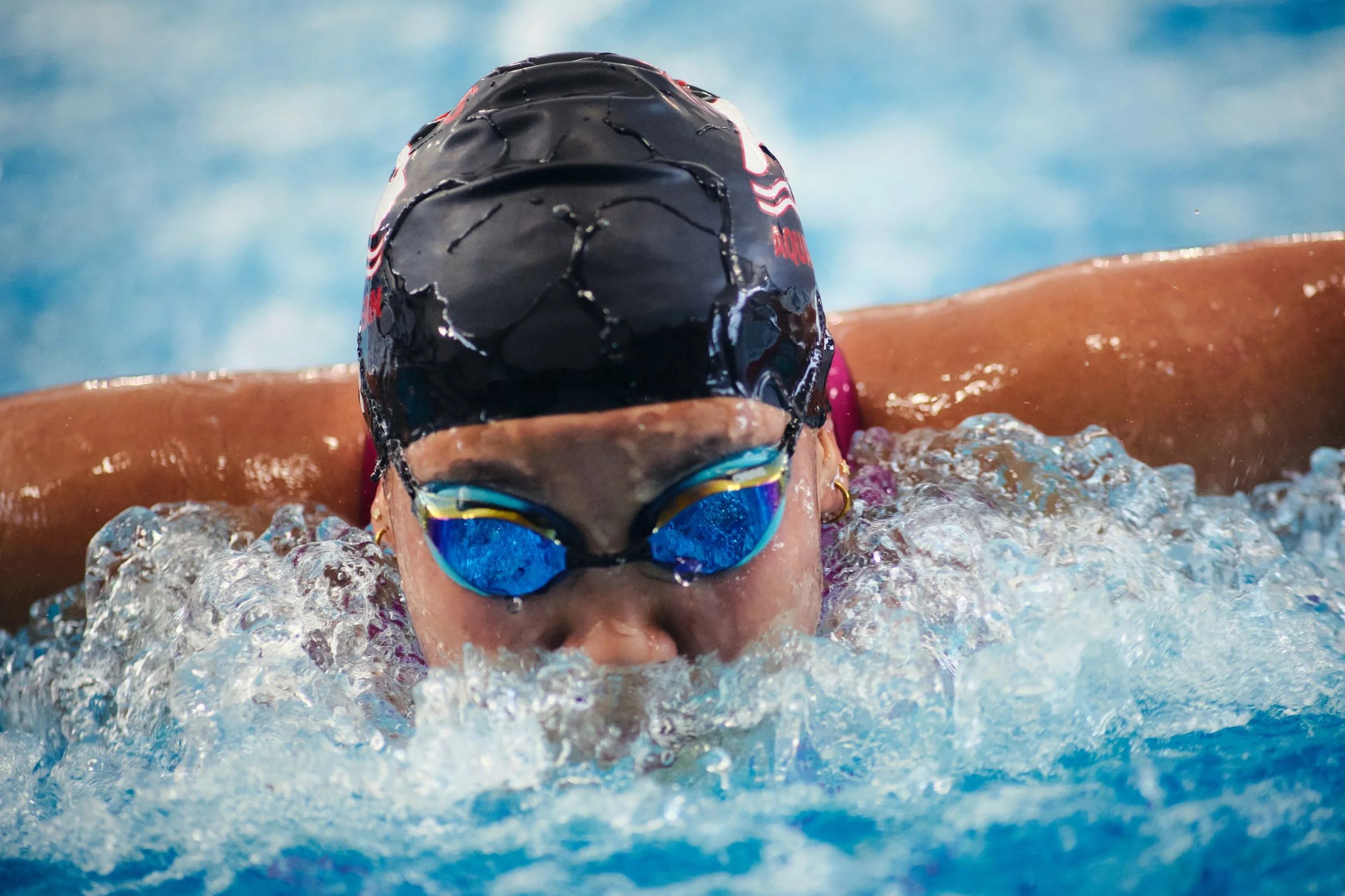 Butterfly swimmer taking a breath mid-stroke