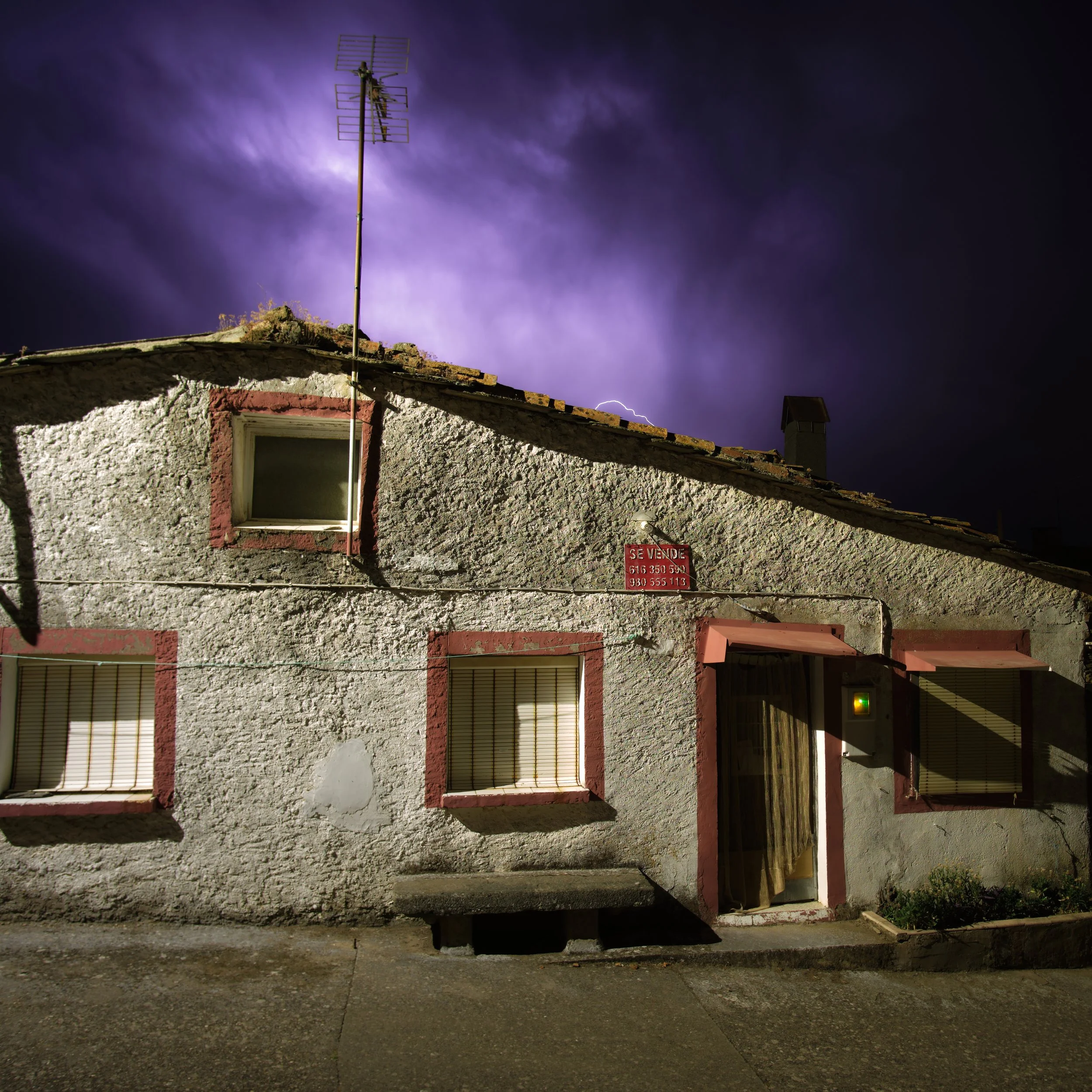 Old stone house under a stormy sky in a Spanish village