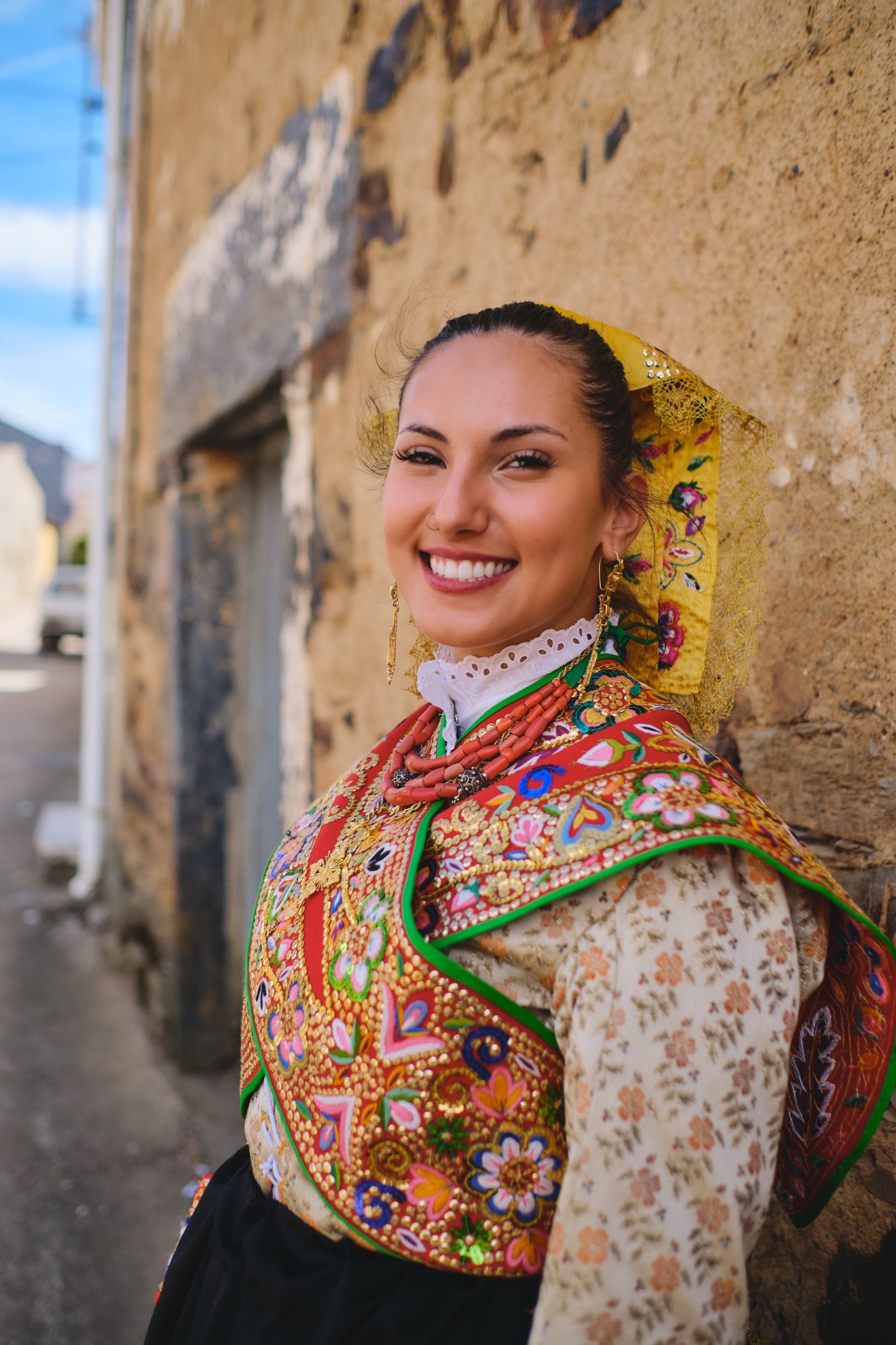 Smiling woman in traditional dress during Los Quintos in Spain