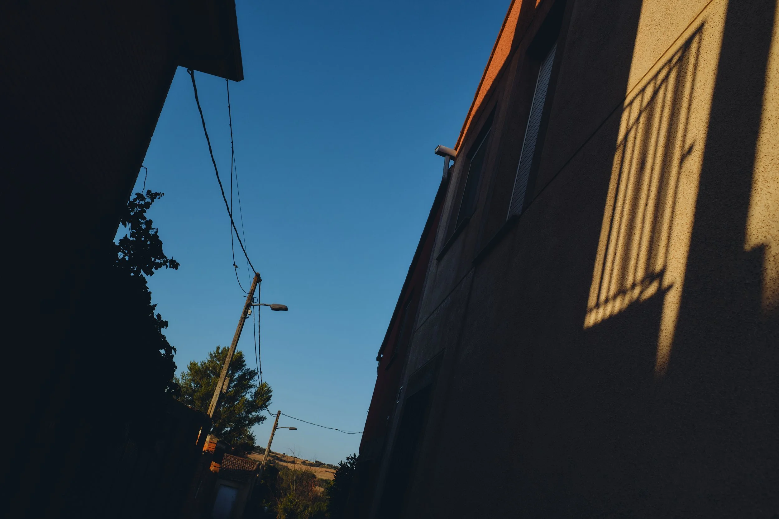 Shadows across a village alley and window in Spain