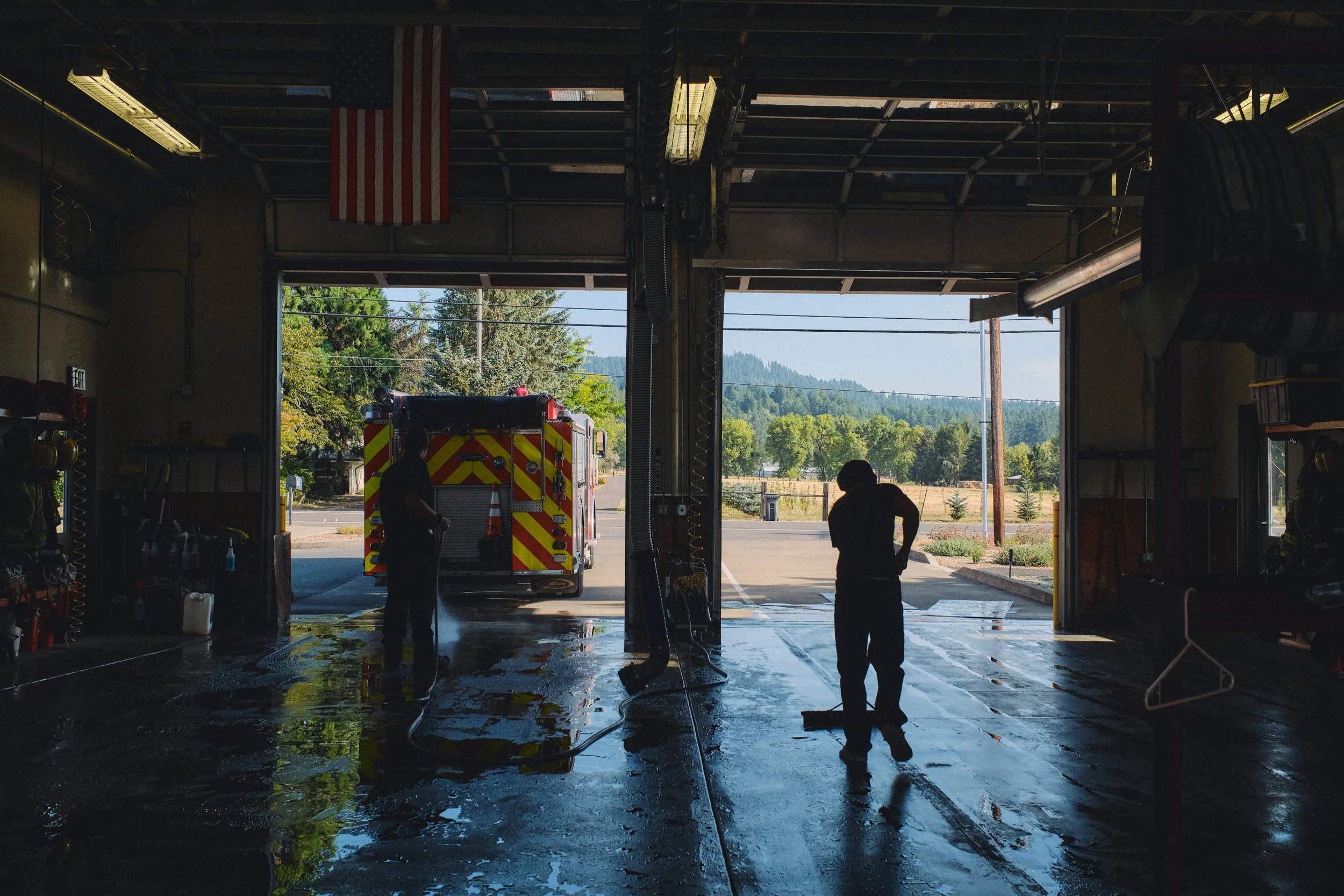 Firefighter washing an engine at a Corvallis fire station