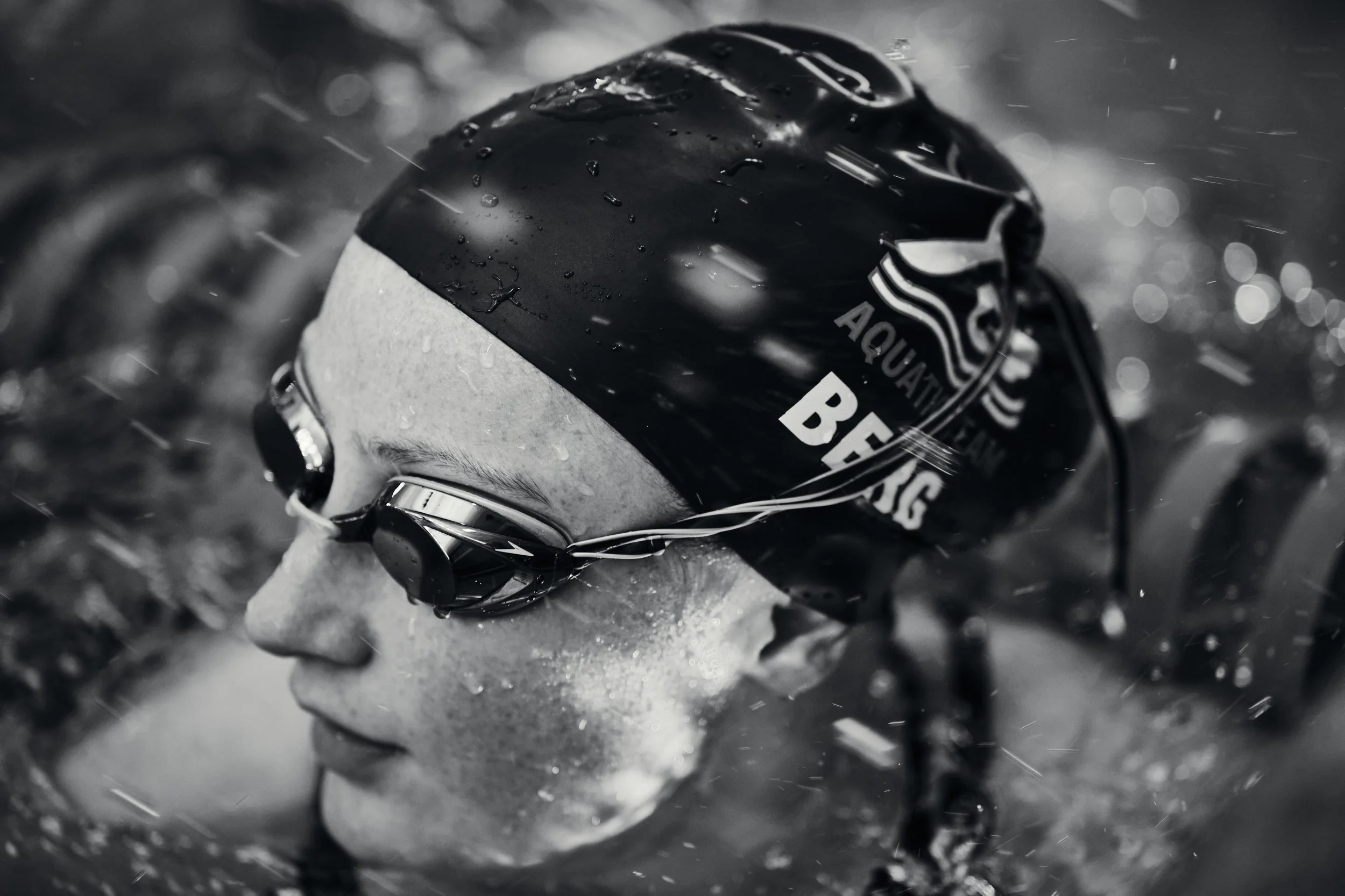 Black and white close-up of a swimmer in goggles