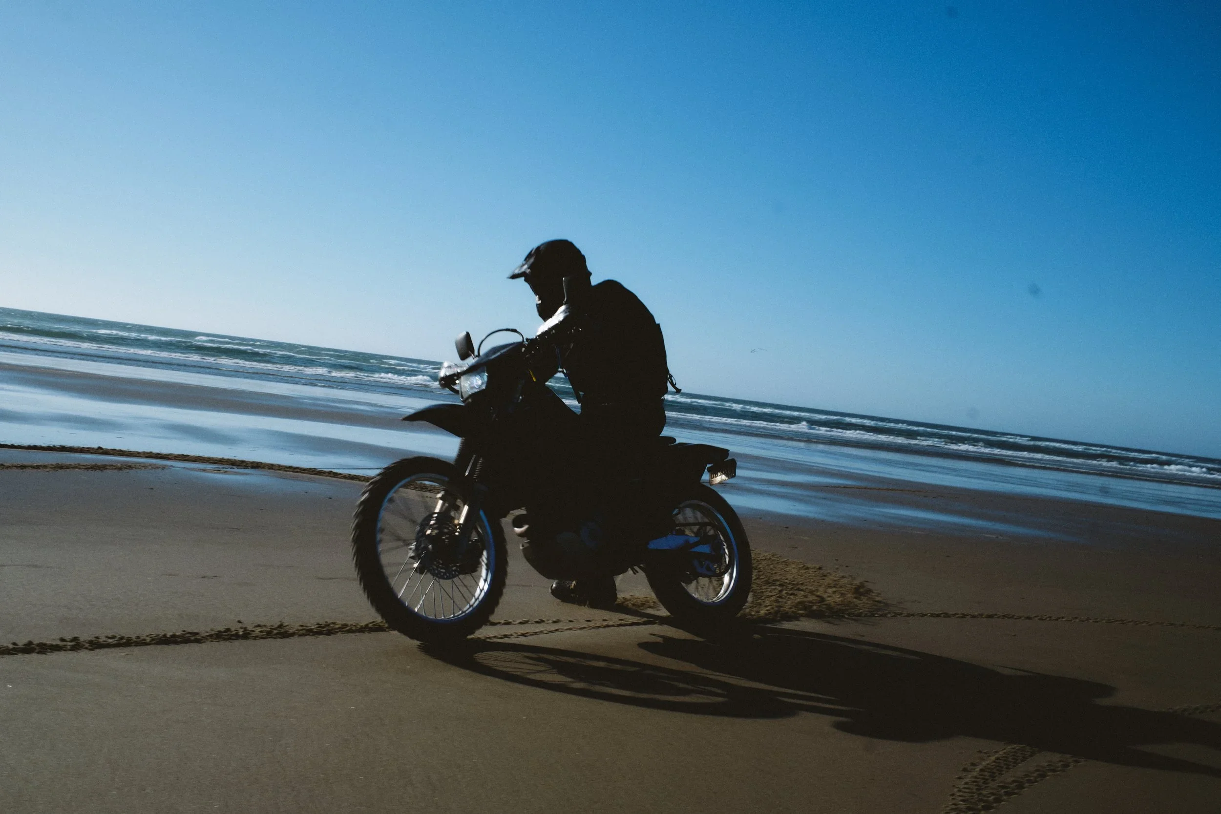 Dirt bike rider silhouetted on the Oregon coast