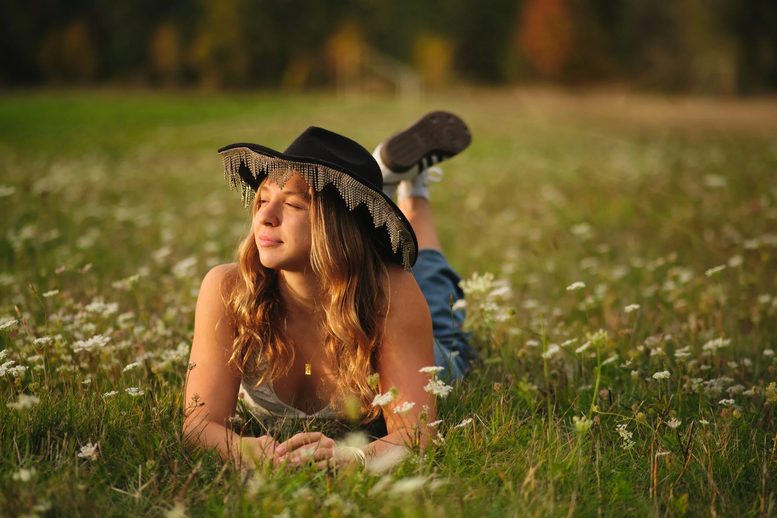 Senior portrait in a wildflower field wearing a hat, Corvallis, Oregon