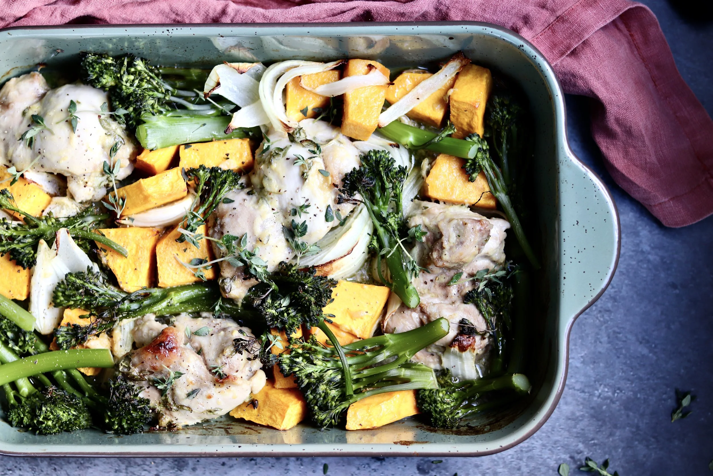 “Lemon thyme chicken served with roasted pumpkin and fresh greens, a healthy and balanced dinner meal”