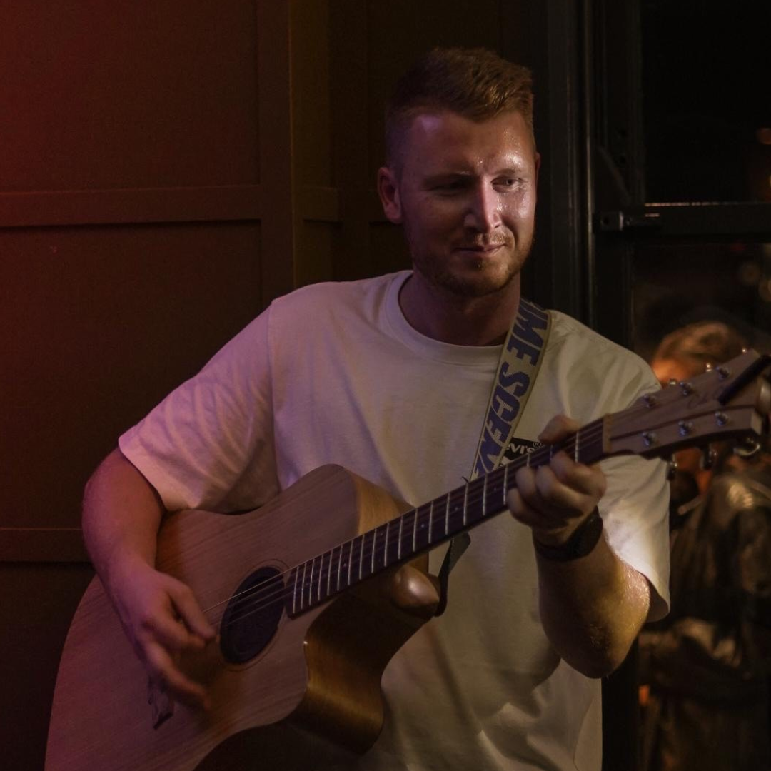 image of red playing guitar