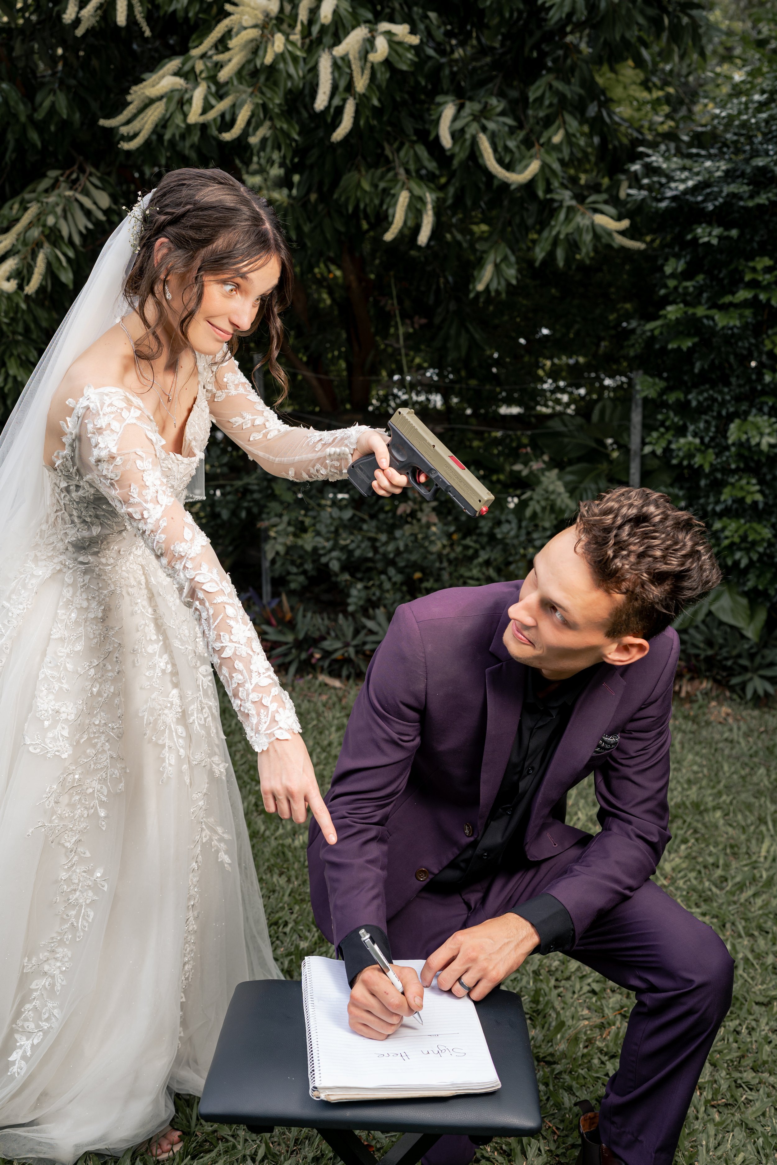 A person wearing a navy blue suit with a white shirt, showing a small Stormtrooper LEGO figure attached to the cuff of their shirt.
