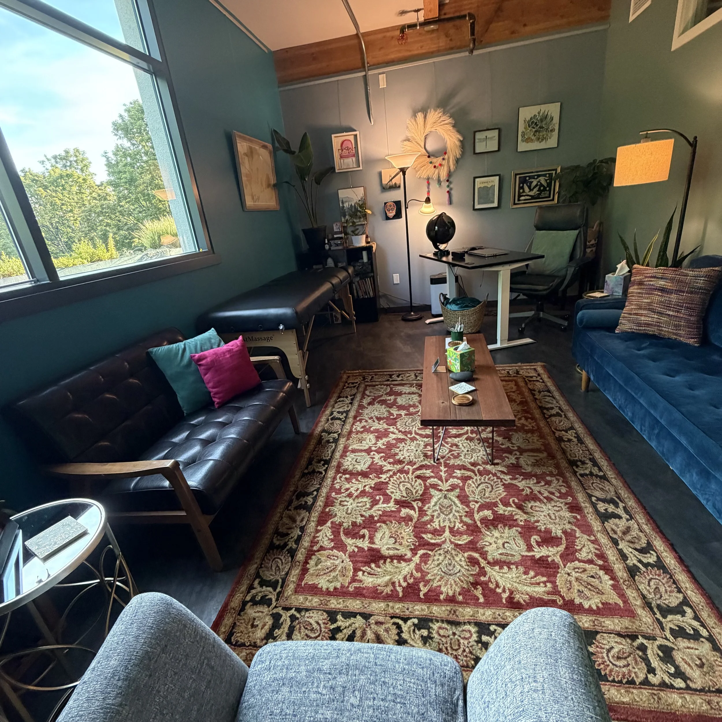 View from East side of large room. Reiki table is usually up for one of our practitioners, can be unfolded for groups. 