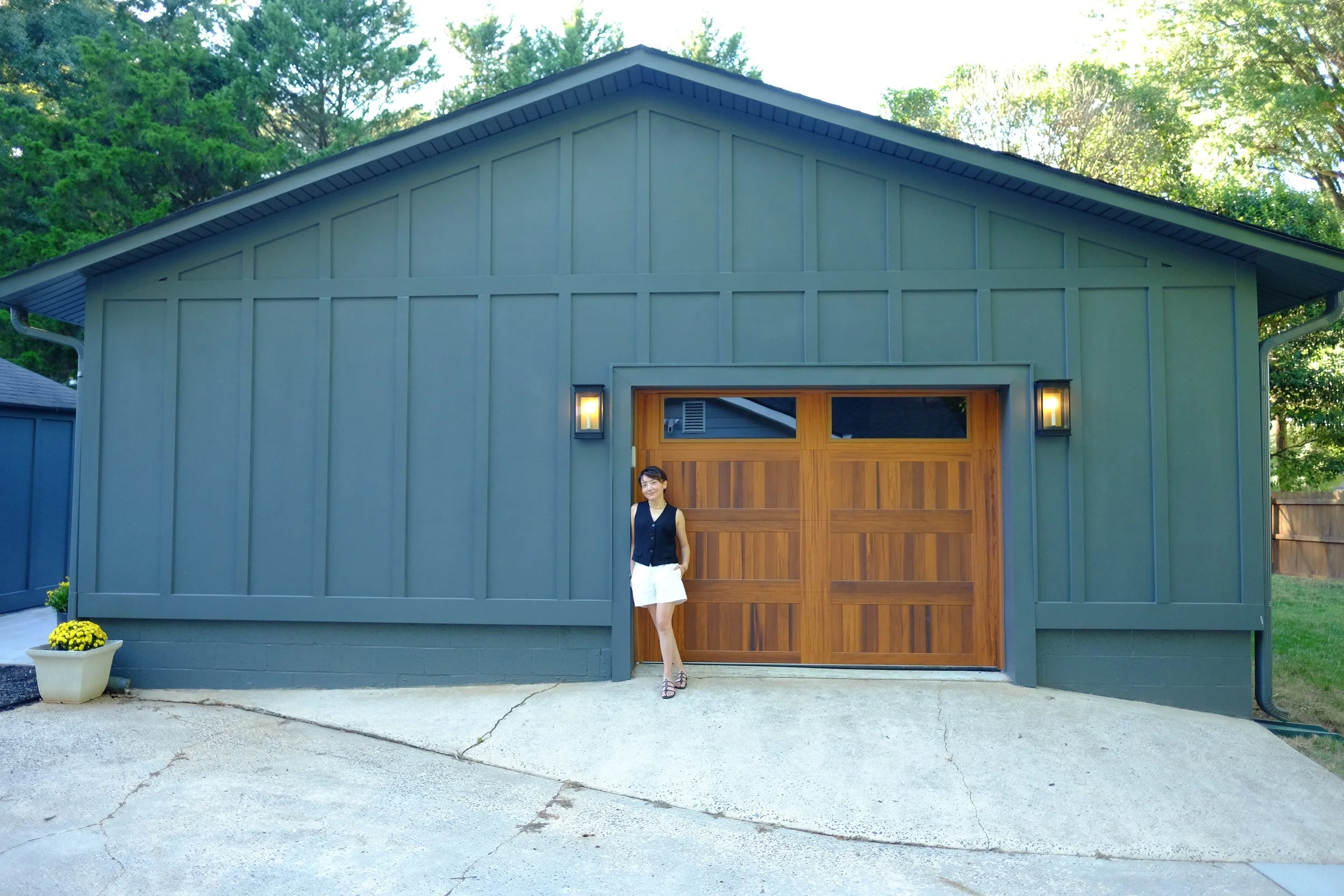 moody garage design with wood garage door