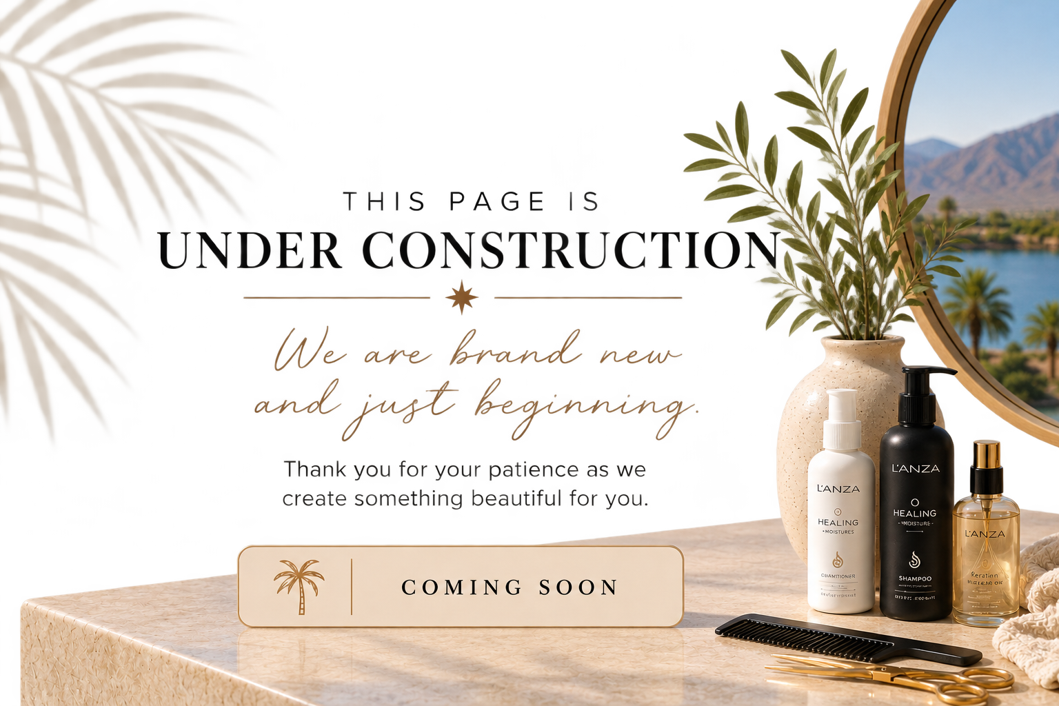 A beauty or skincare product display with four bottles, a comb, and a mirror, with a landscape of mountains and water outside the mirror. Text overlay announces an under construction message and upcoming launch.