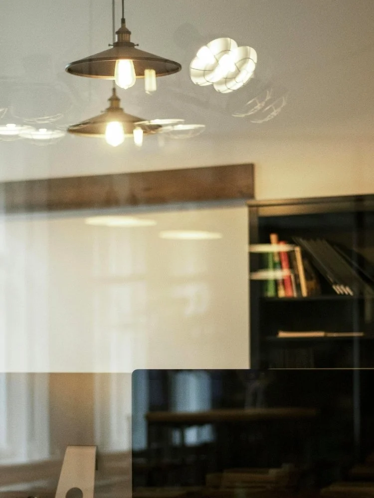 Warm creative office pendant lights bookshelf Connected Legal Commercial Sydney