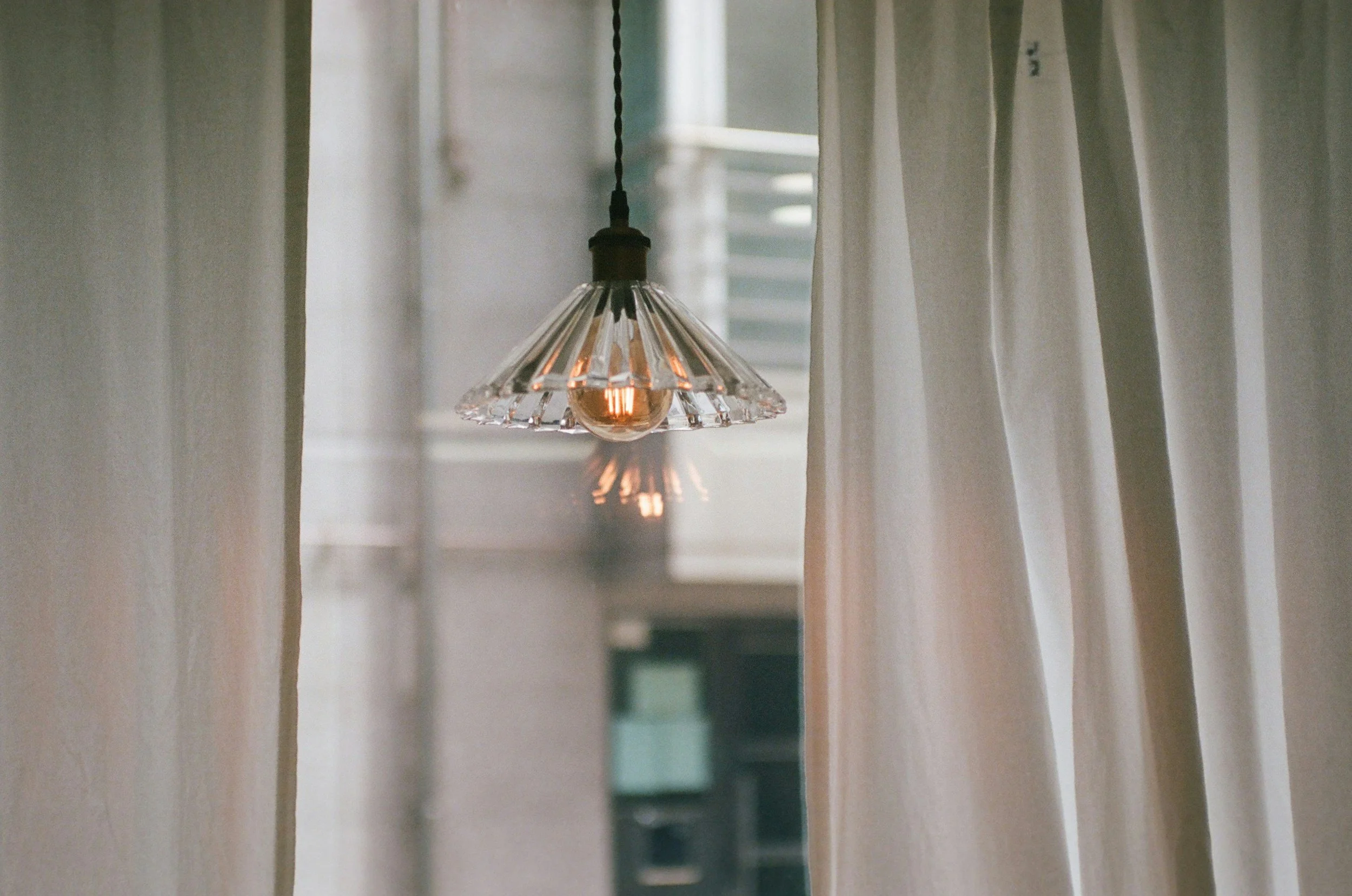 light bulb near curtained window